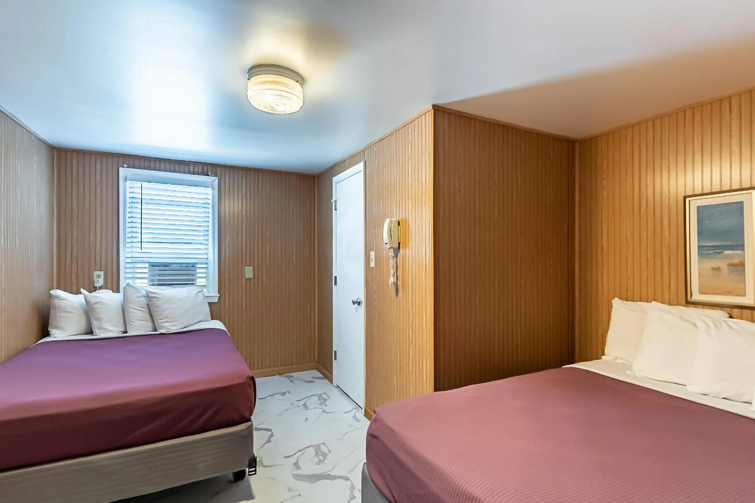 Bed in Boardwalk Sand & Surf Beach Hotel Oceanfront