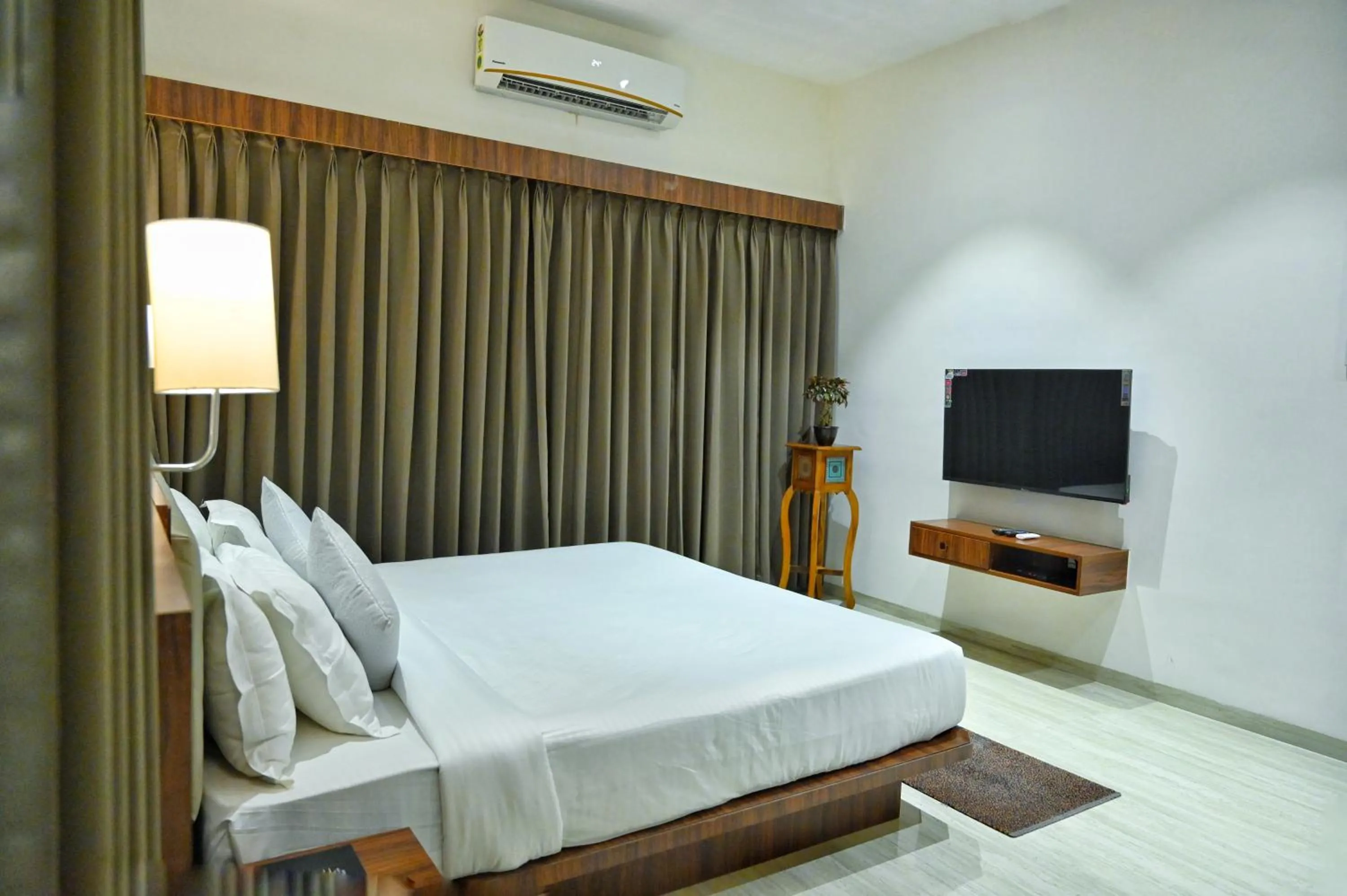 Communal lounge/ TV room, Bed in The One Hotel Nashik