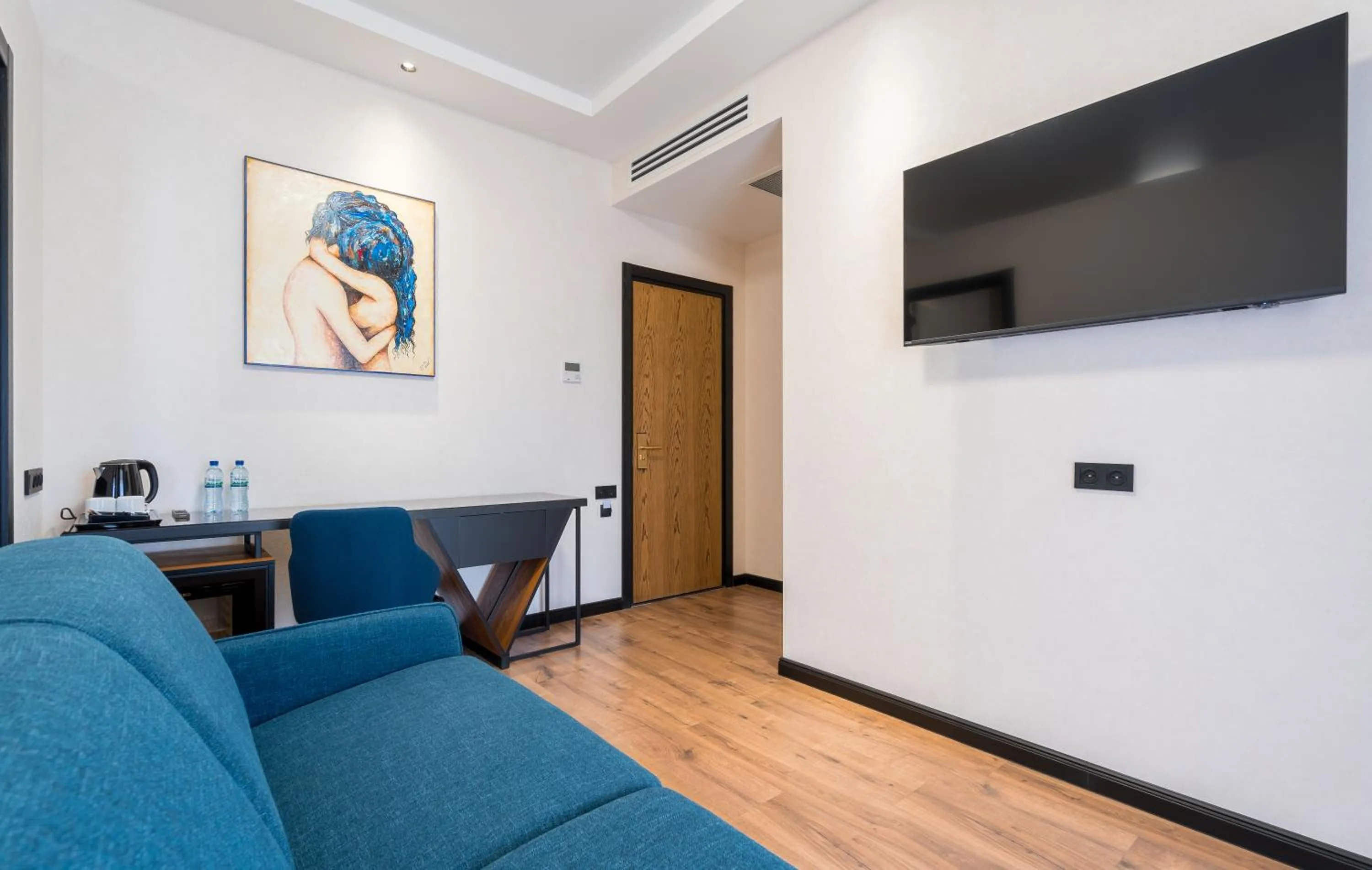 Communal lounge/ TV room in Olympus Hotel By Umbrella