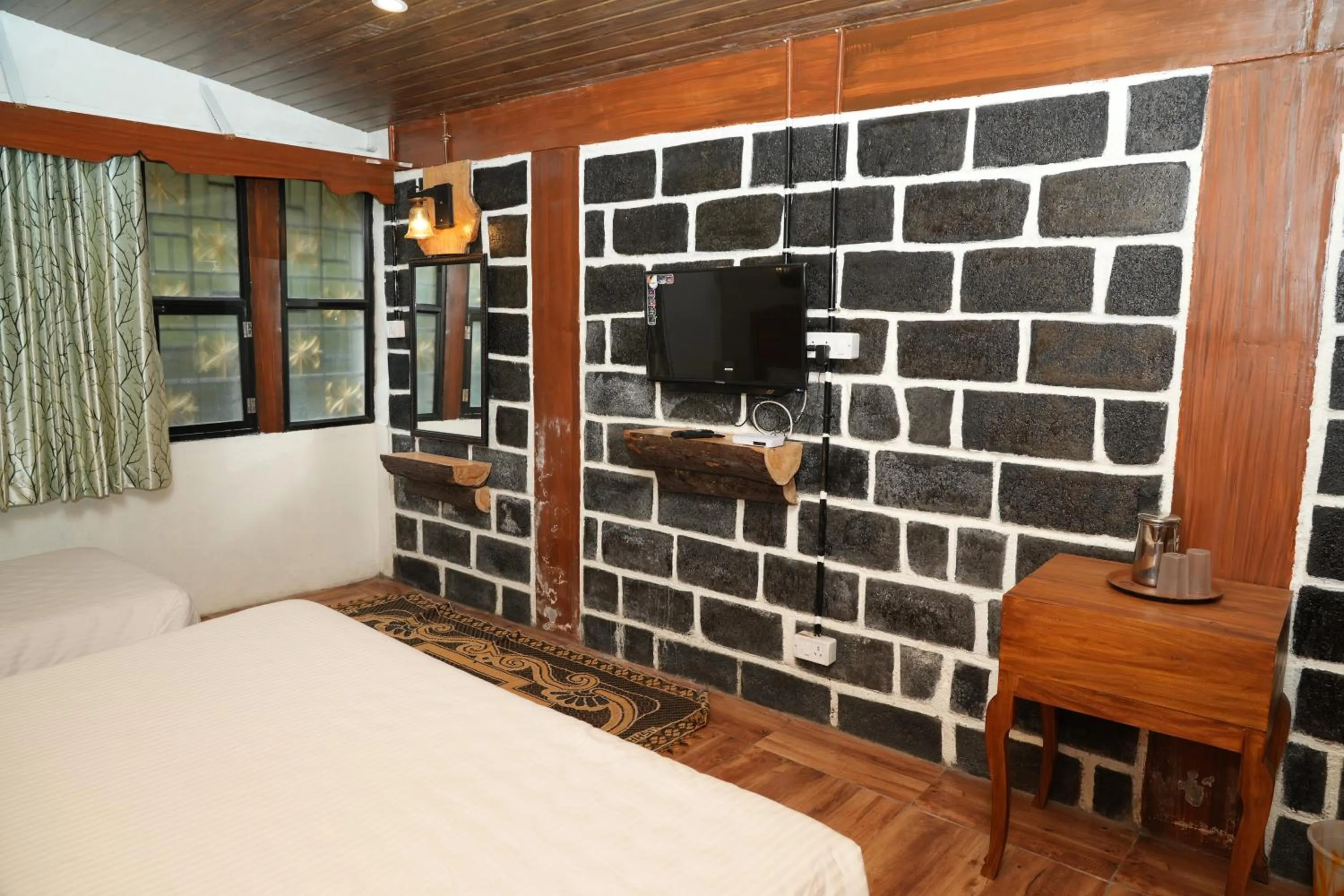Bed in Vetrivel International by Brown Tree Resorts
