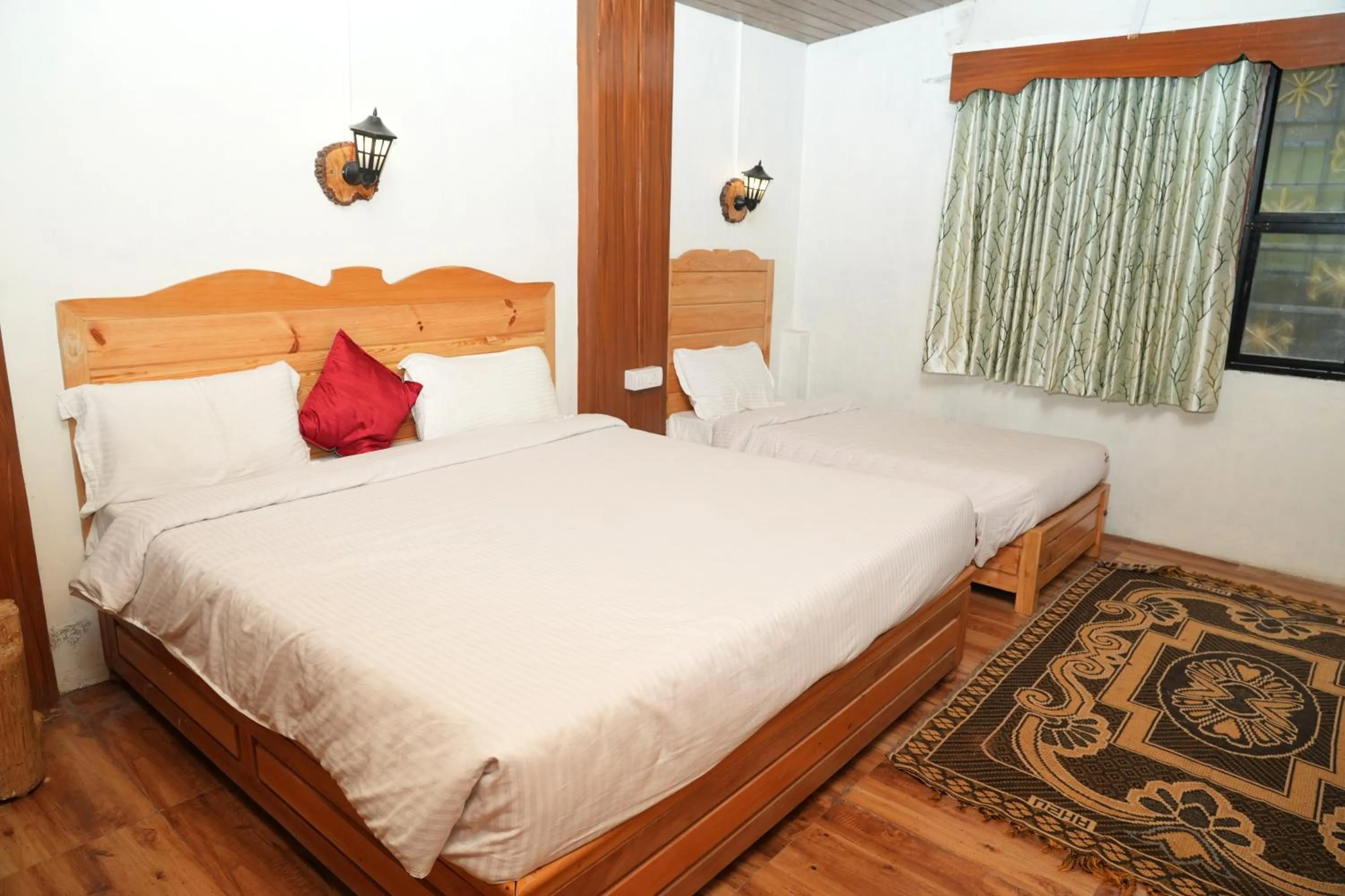 Bed in Vetrivel International by Brown Tree Resorts