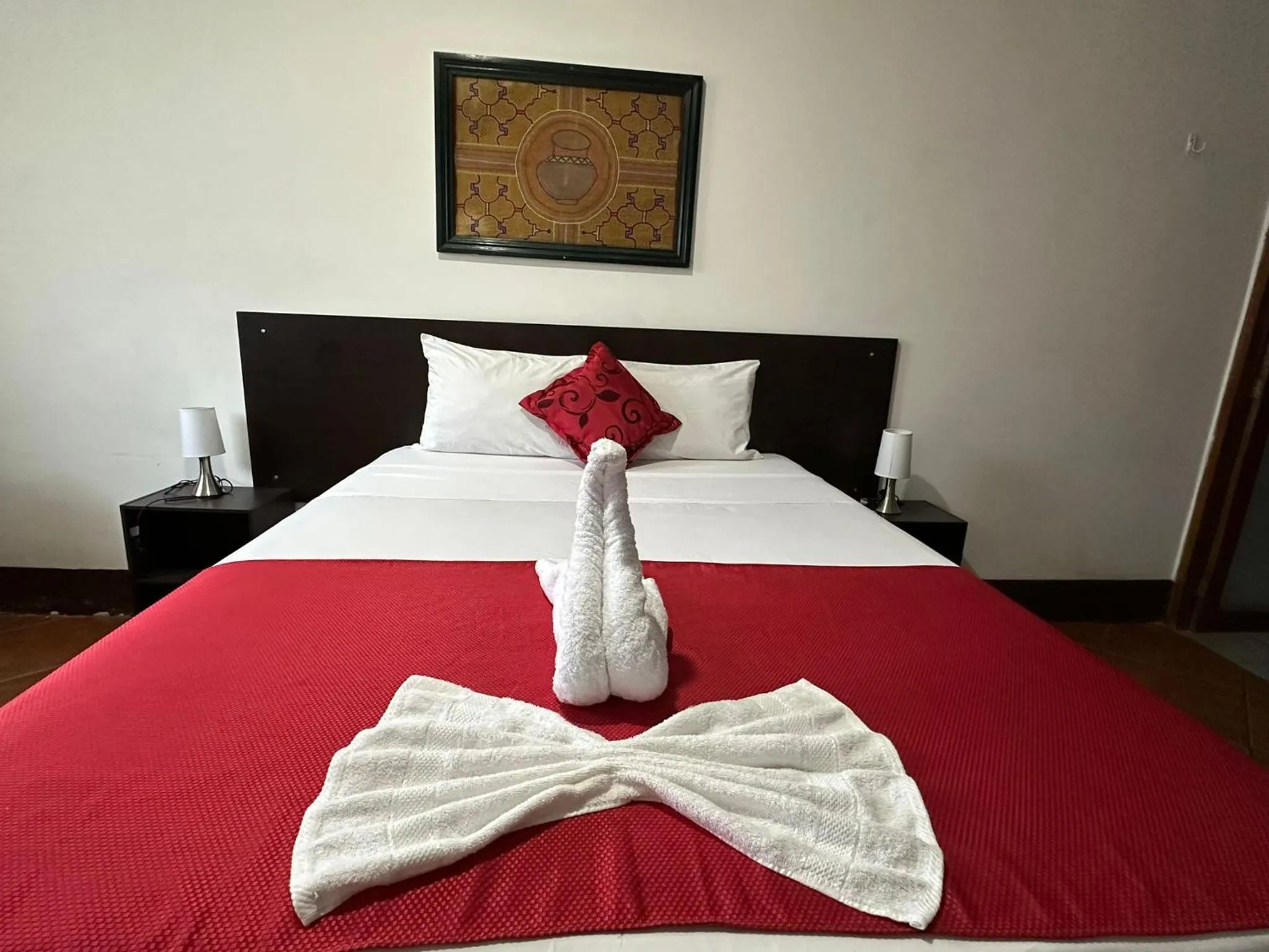 Bed in La Posada del Cauchero Hotel & Suites