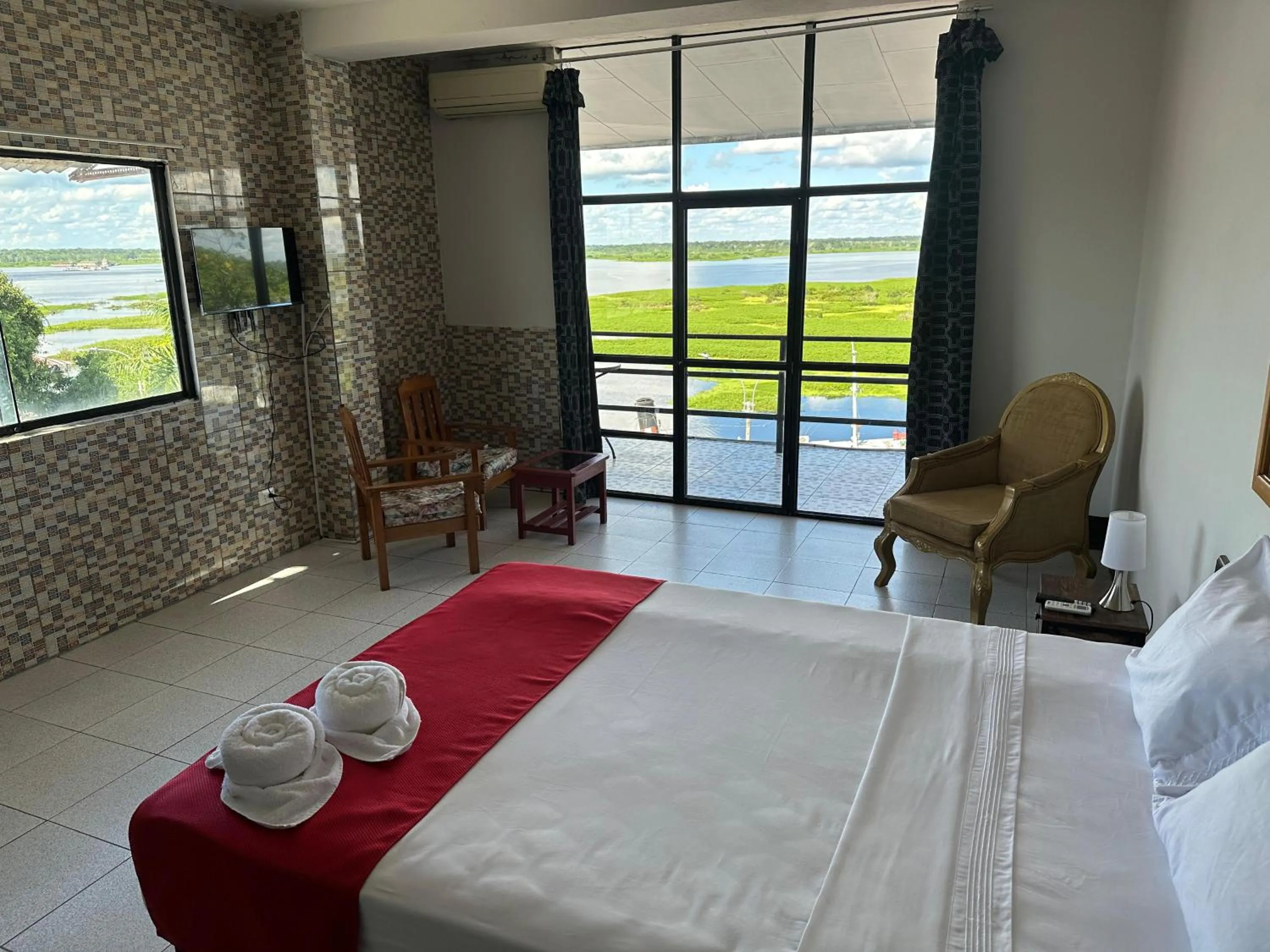 Photo of the whole room, Bed in La Posada del Cauchero Hotel & Suites