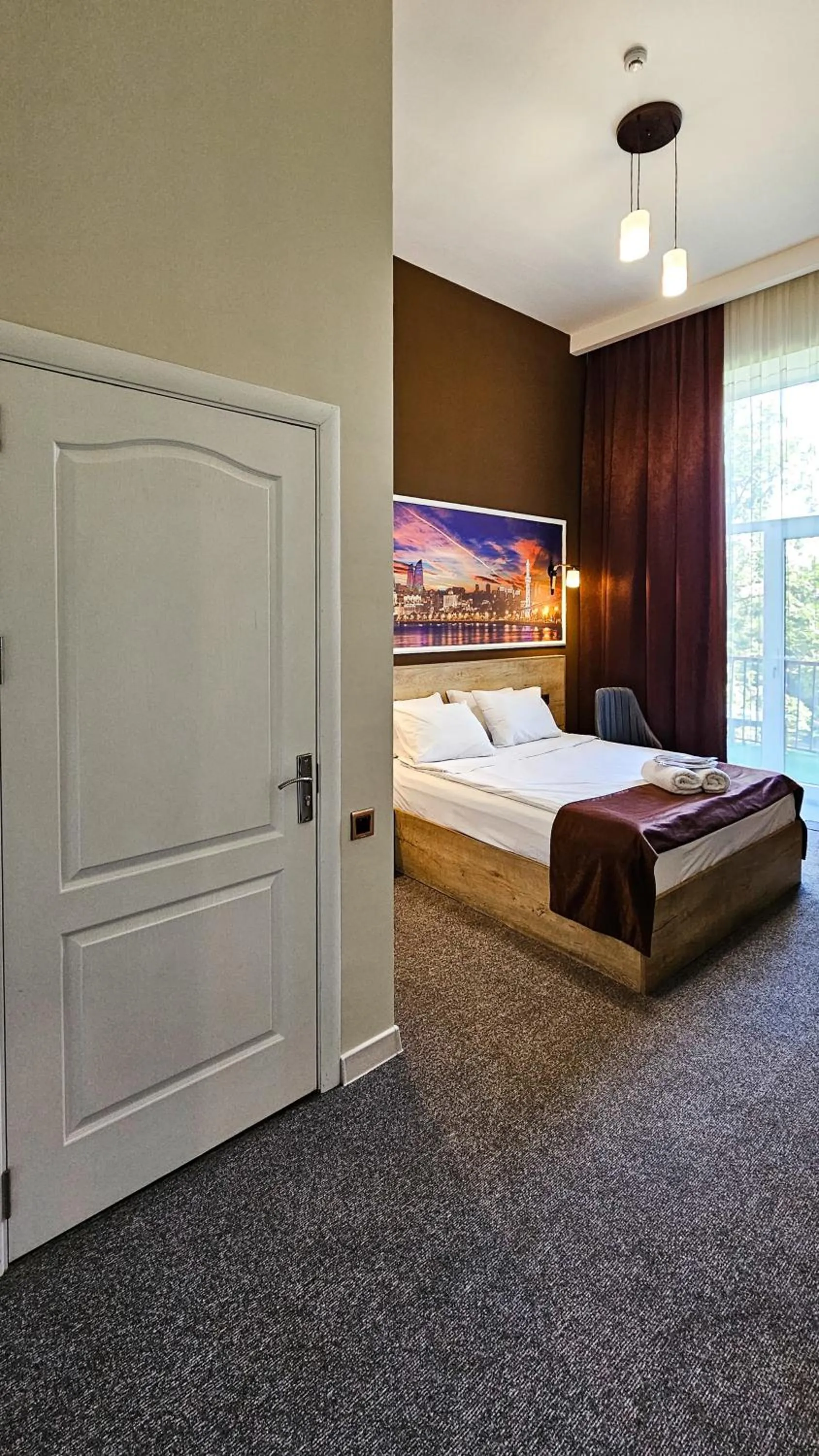 Bed in ELYSIUM HOTEL