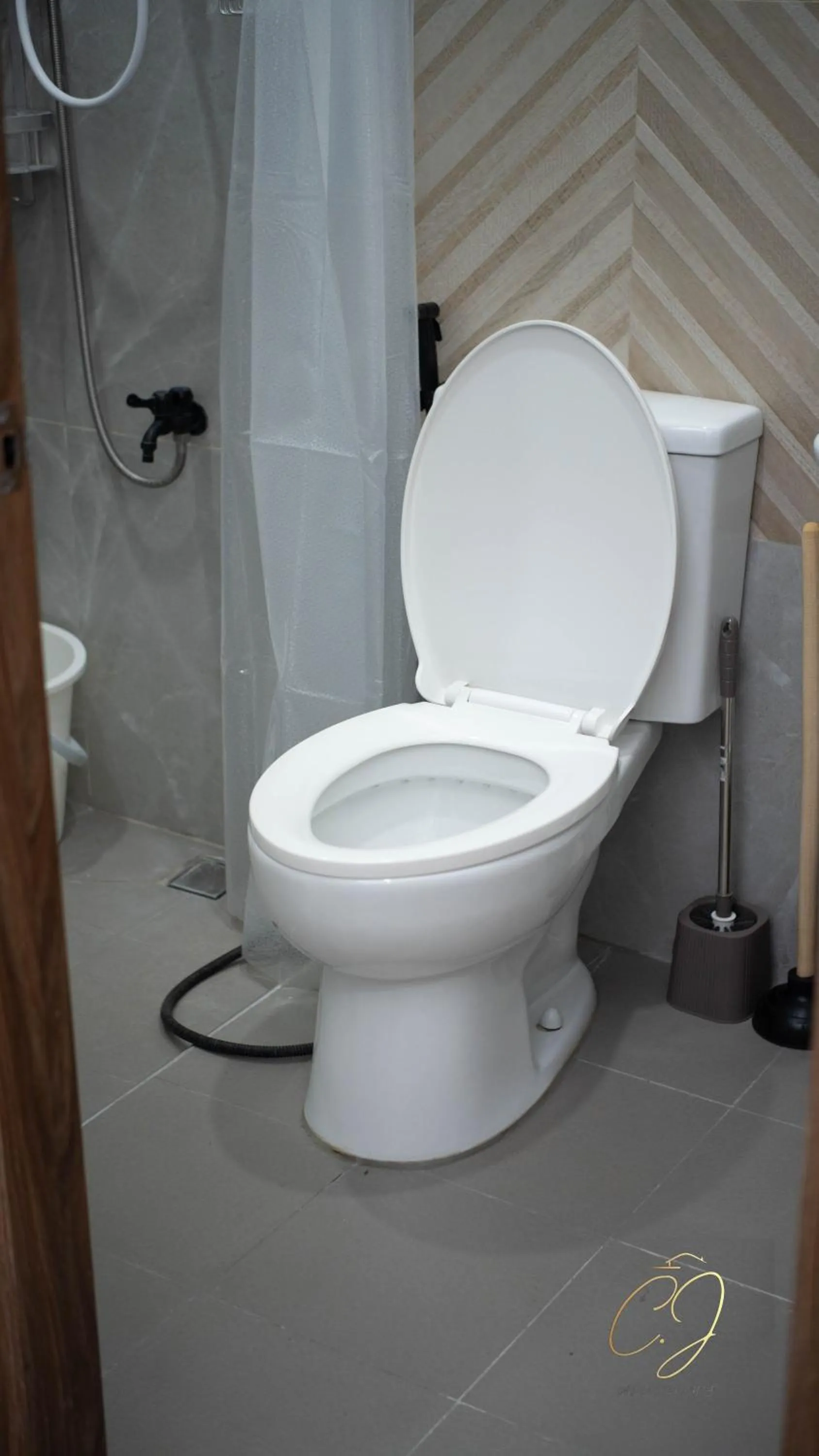 Toilet in CJ Apartments