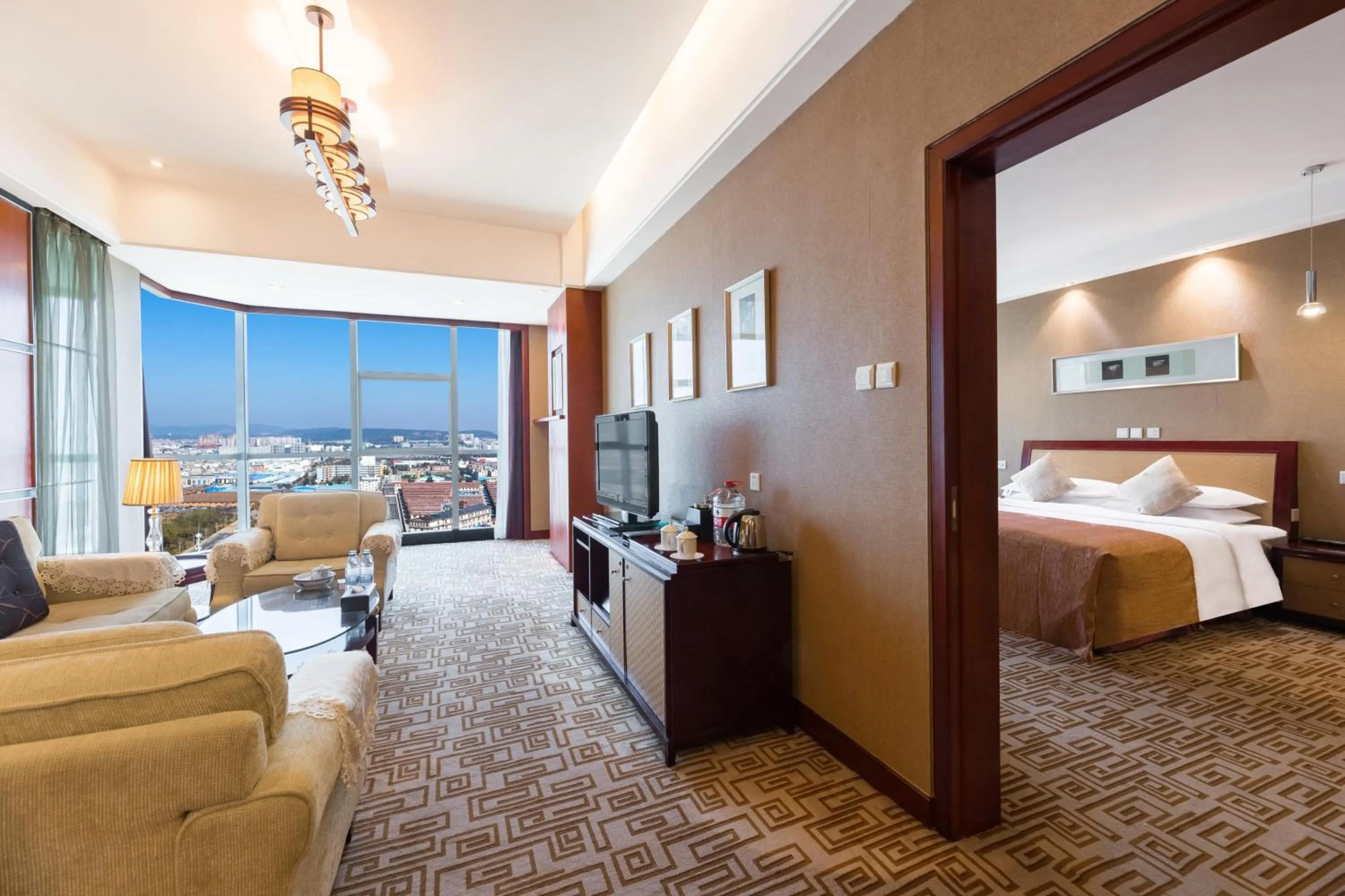 Communal lounge/ TV room, Bed in Empark Grand Hotel Kunming