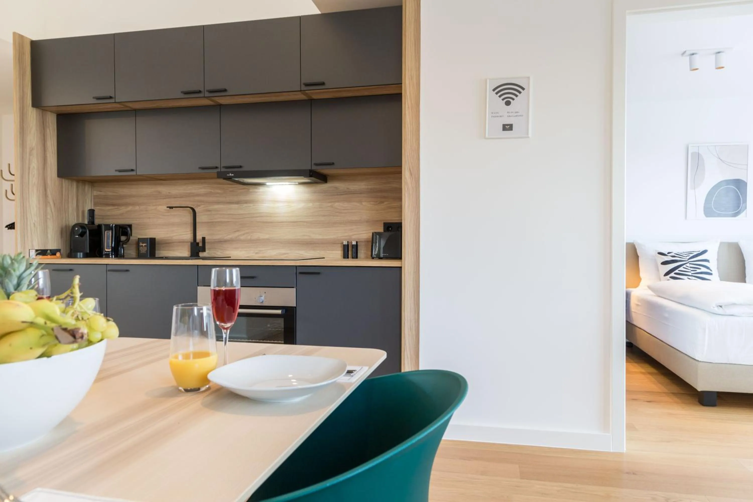 Kitchen or kitchenette, Bed in living TIMELESS - Adler Apartments Sasbachwalden