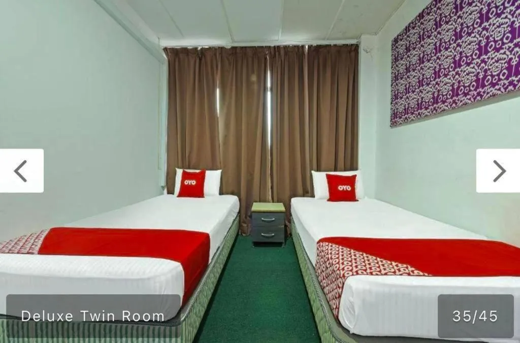 Bed in SYAHIRAH HOTEL