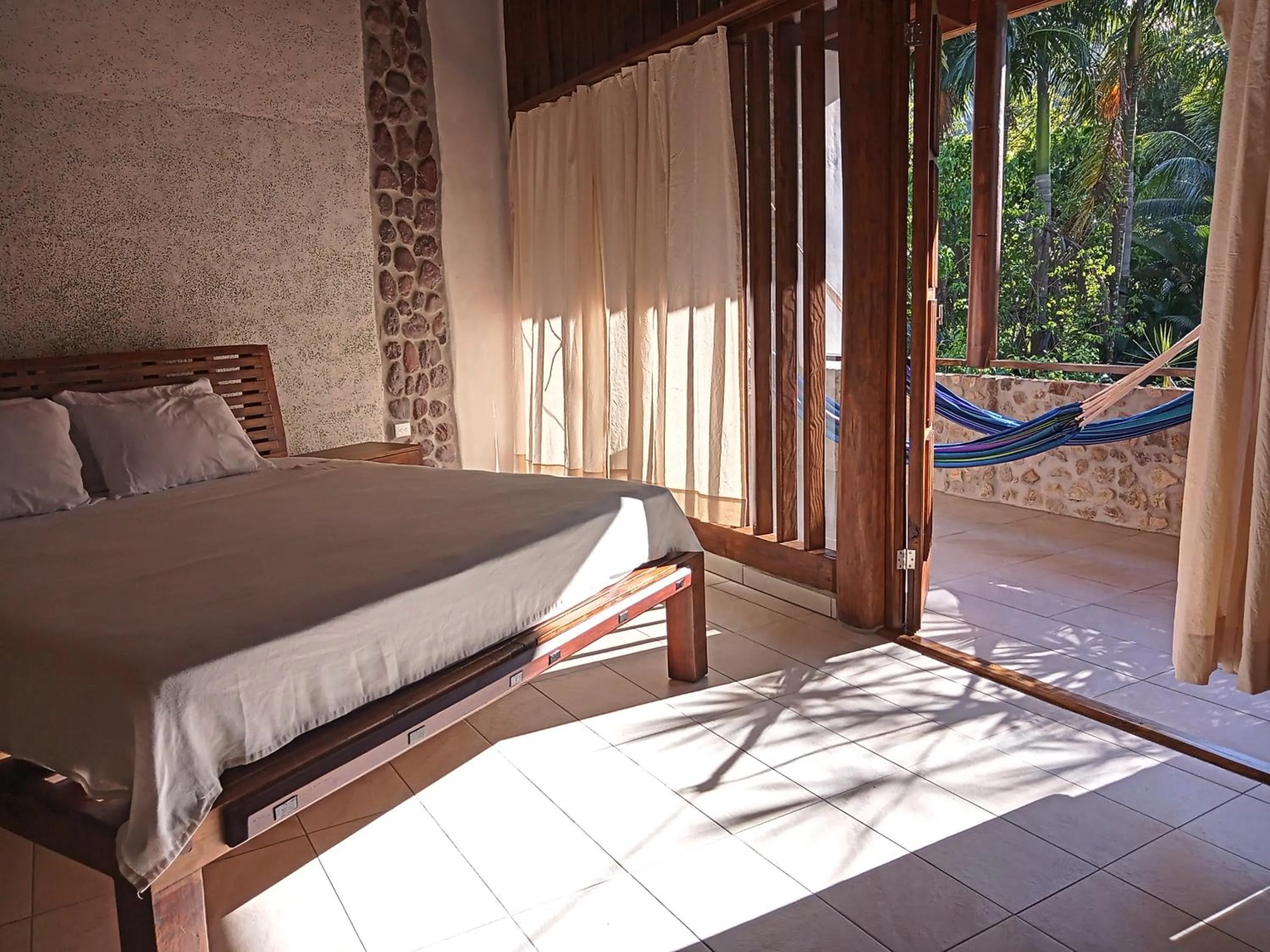 Bed in Omega Tours Eco-Jungle Lodge