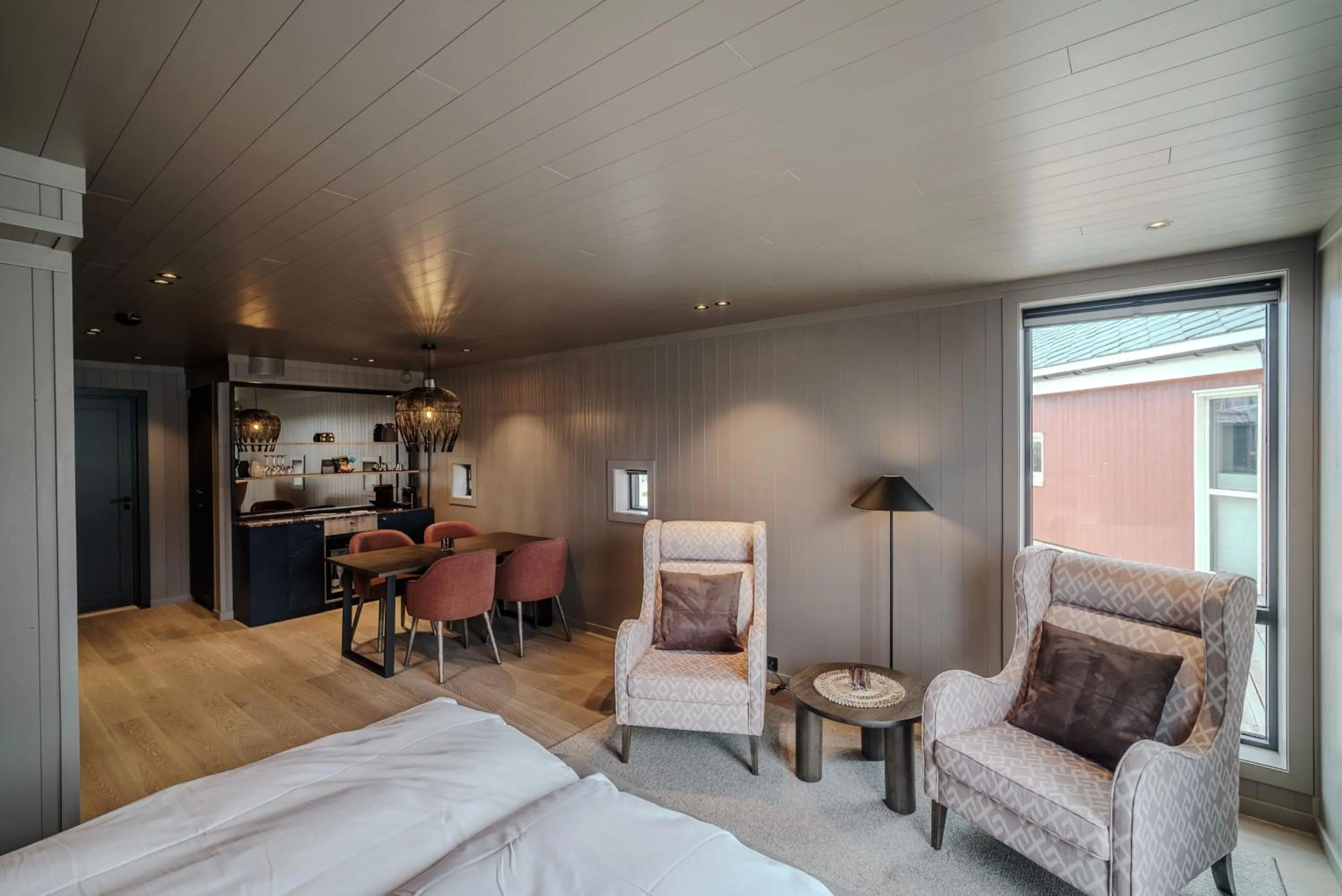 Living room, Bed in Henningsvær Bryggehotell - by Classic Norway Hotels