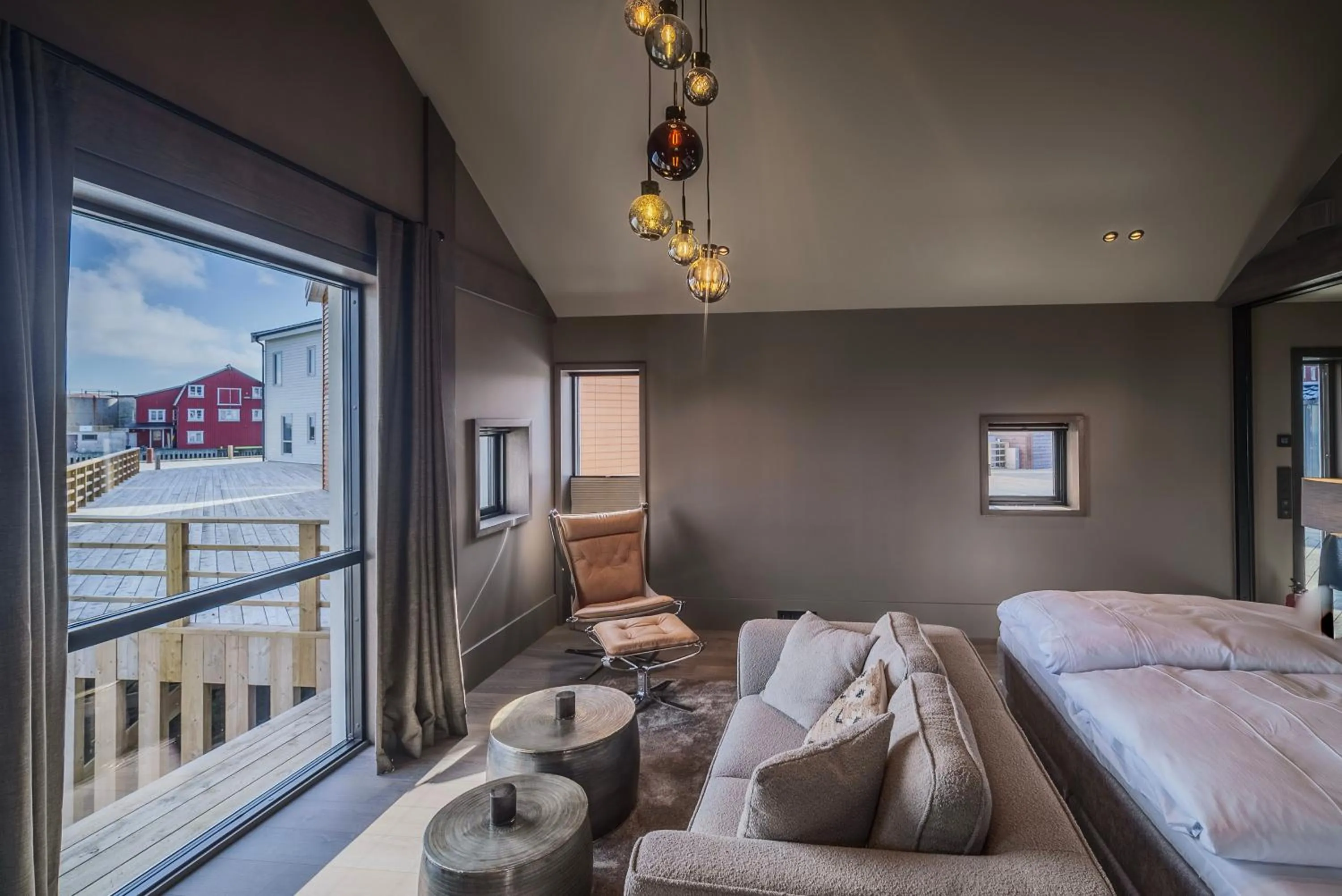 Living room, Bed in Henningsvær Bryggehotell - by Classic Norway Hotels
