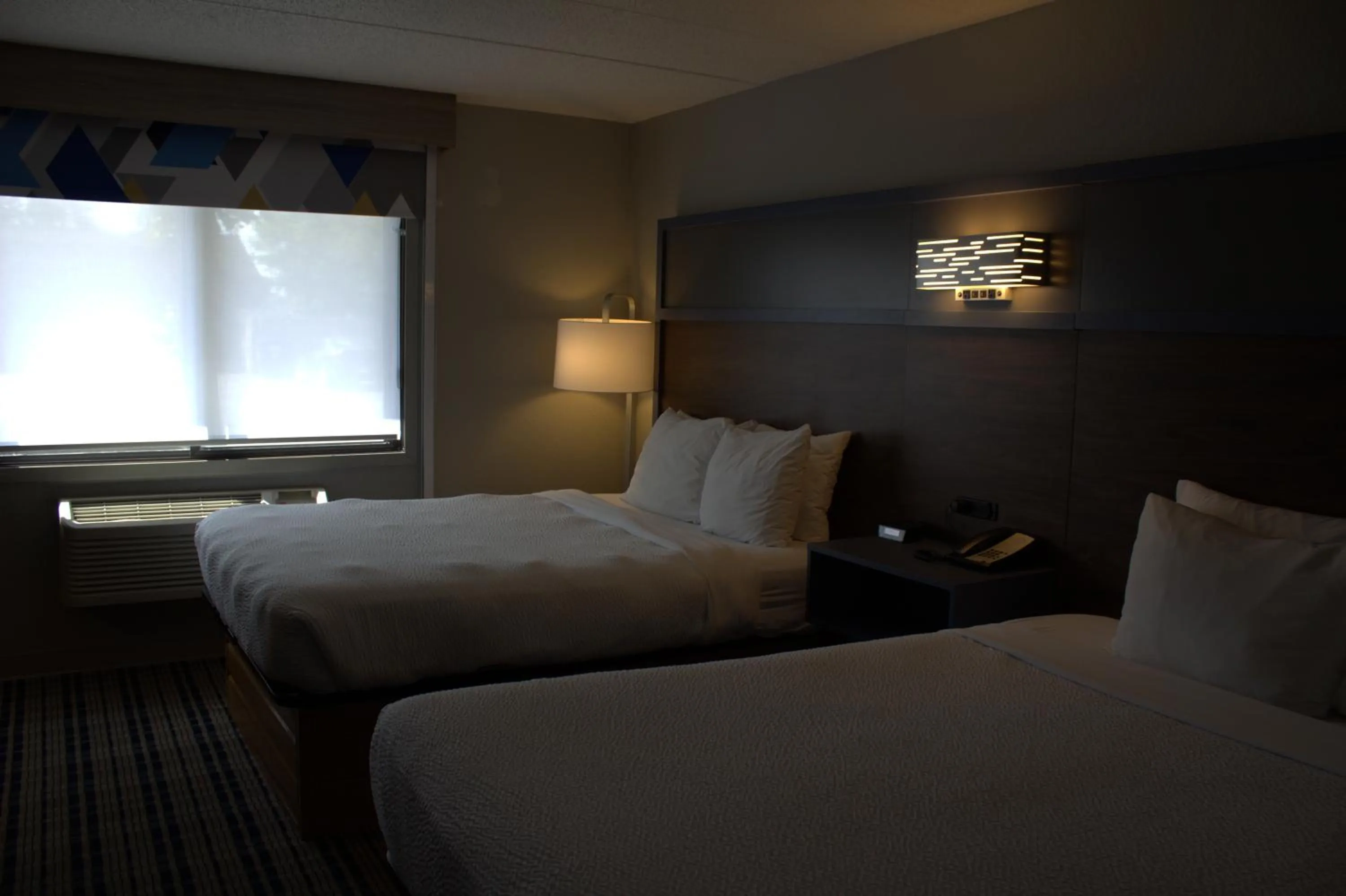 Bed in AmericInn by Wyndham Worthington