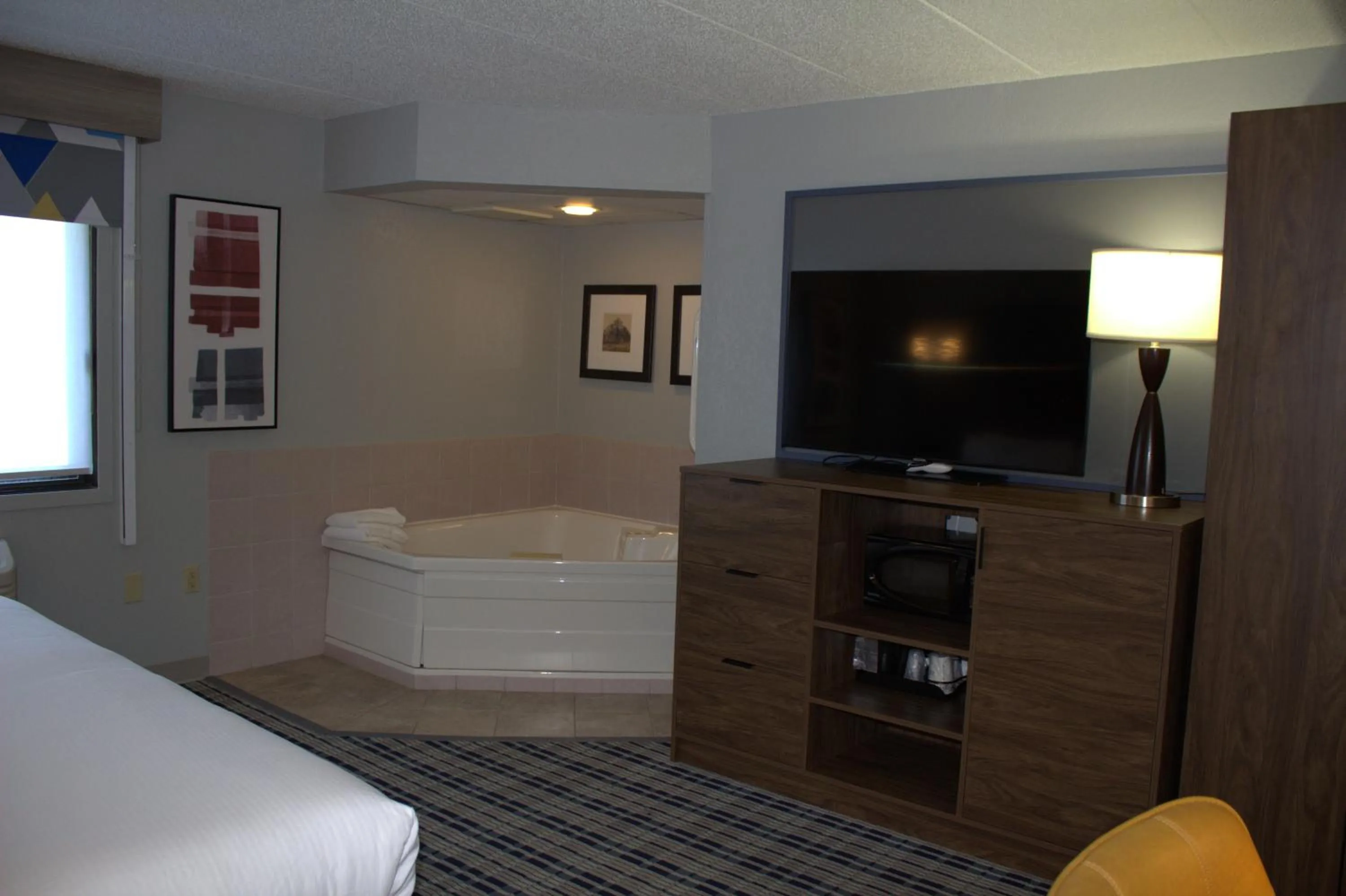 Bed in AmericInn by Wyndham Worthington