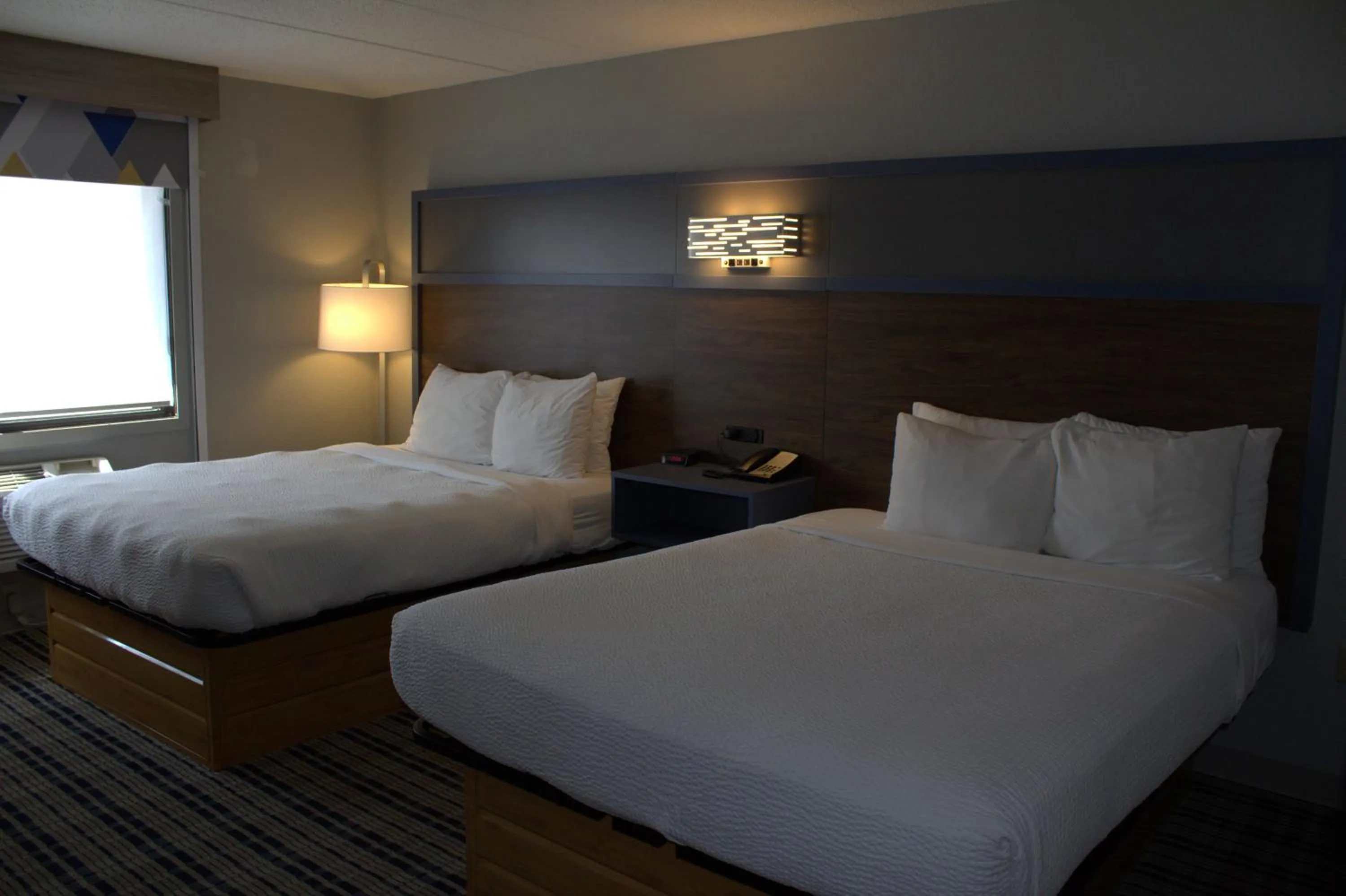 Bed in AmericInn by Wyndham Worthington