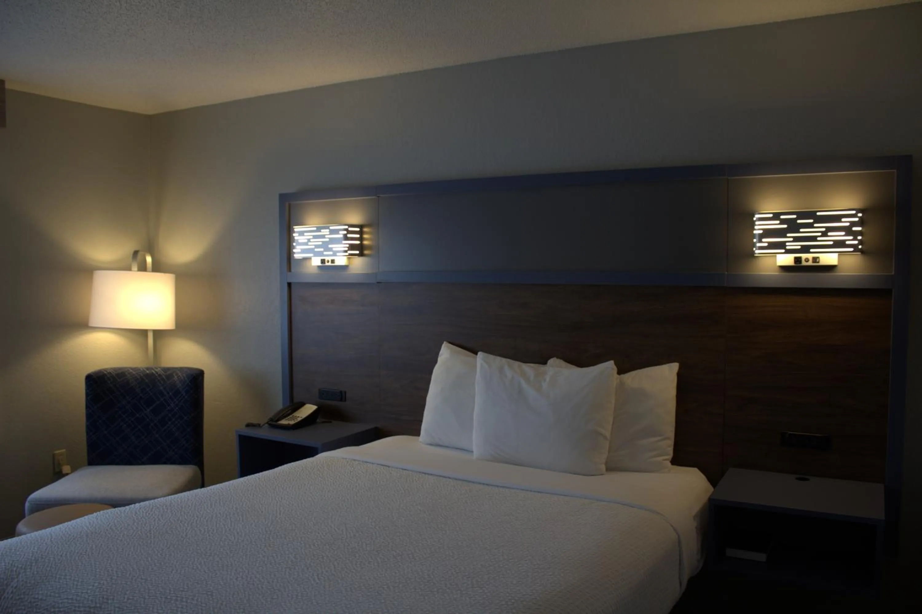 Bed in AmericInn by Wyndham Worthington