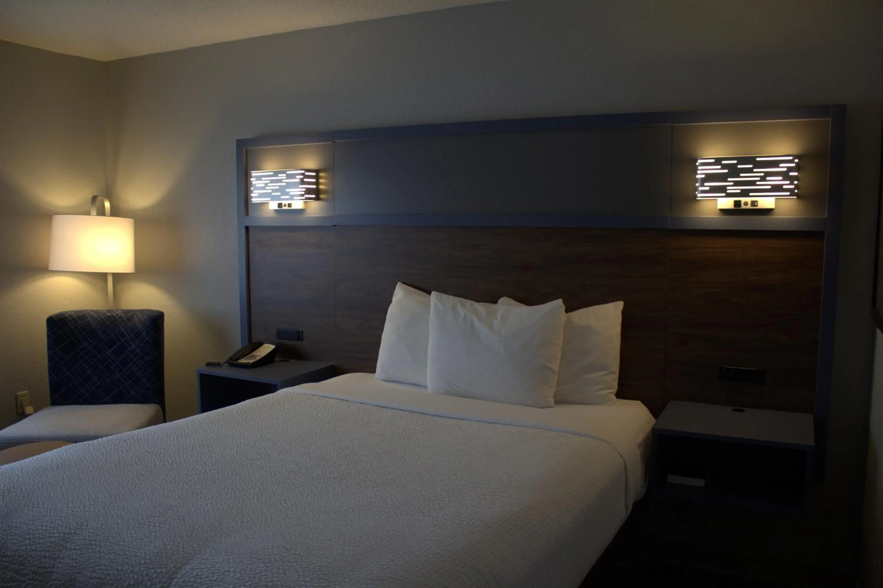 Bed in AmericInn by Wyndham Worthington