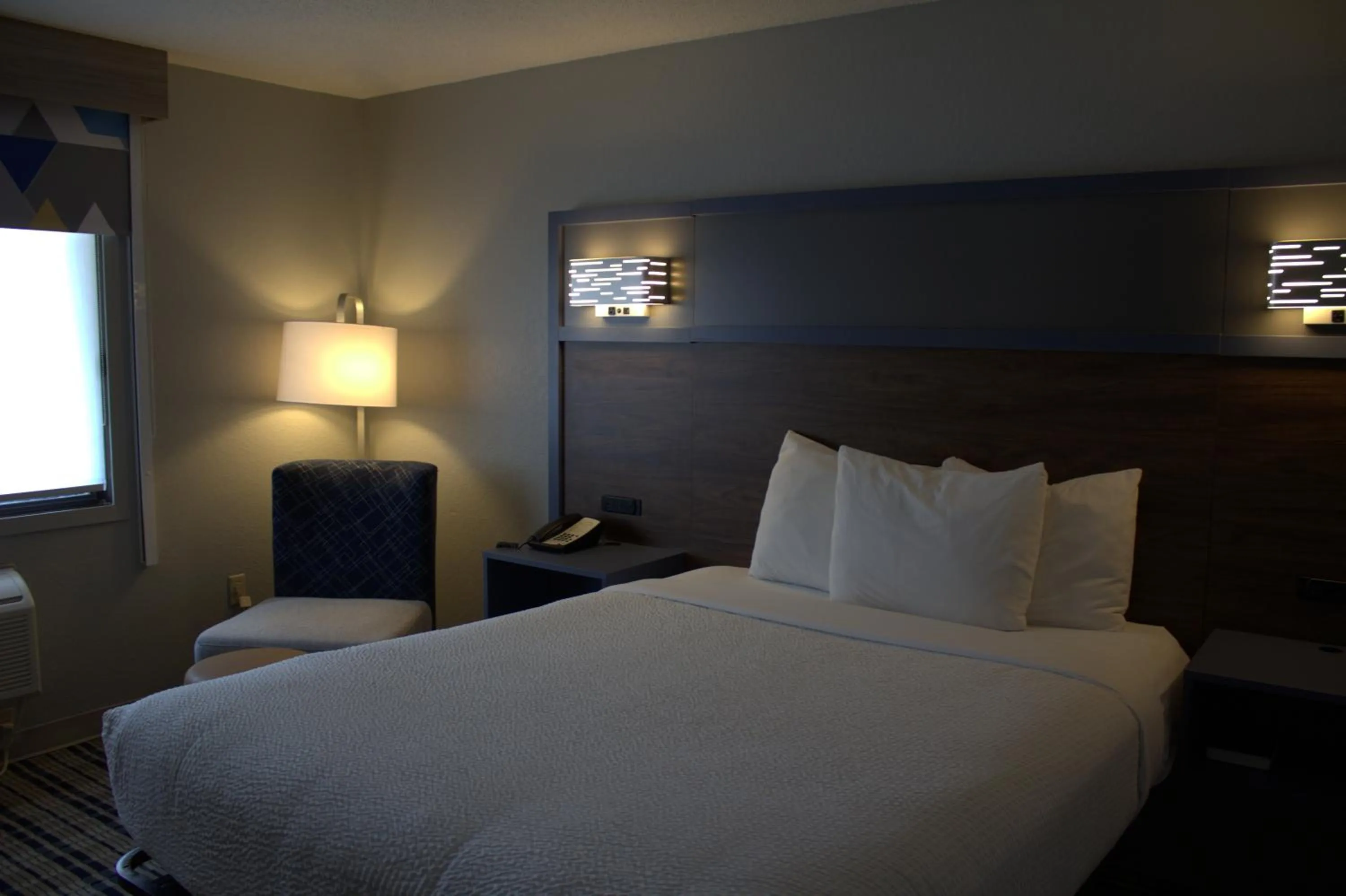 Bed in AmericInn by Wyndham Worthington