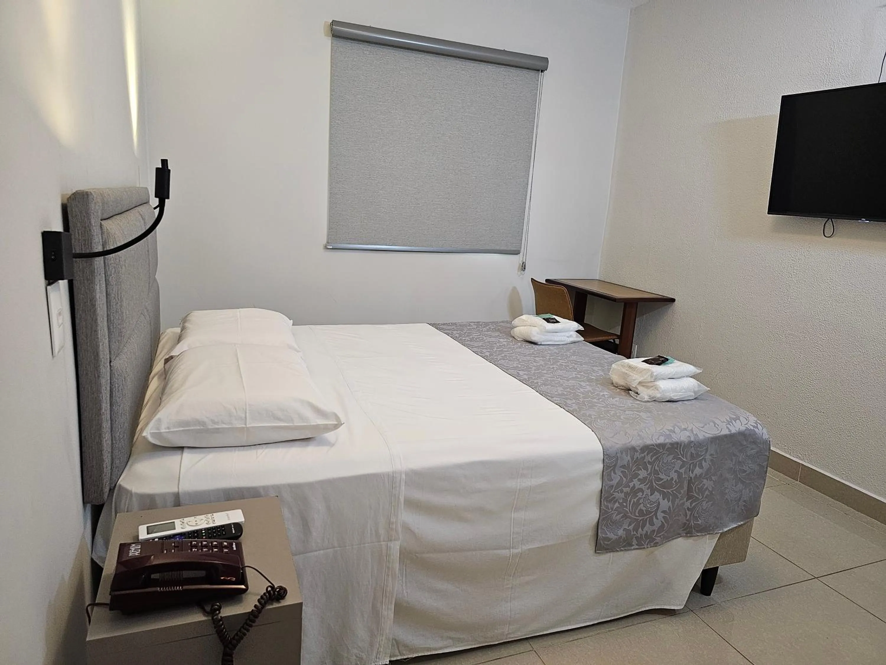 Bed in Optimum Plaza Hotel