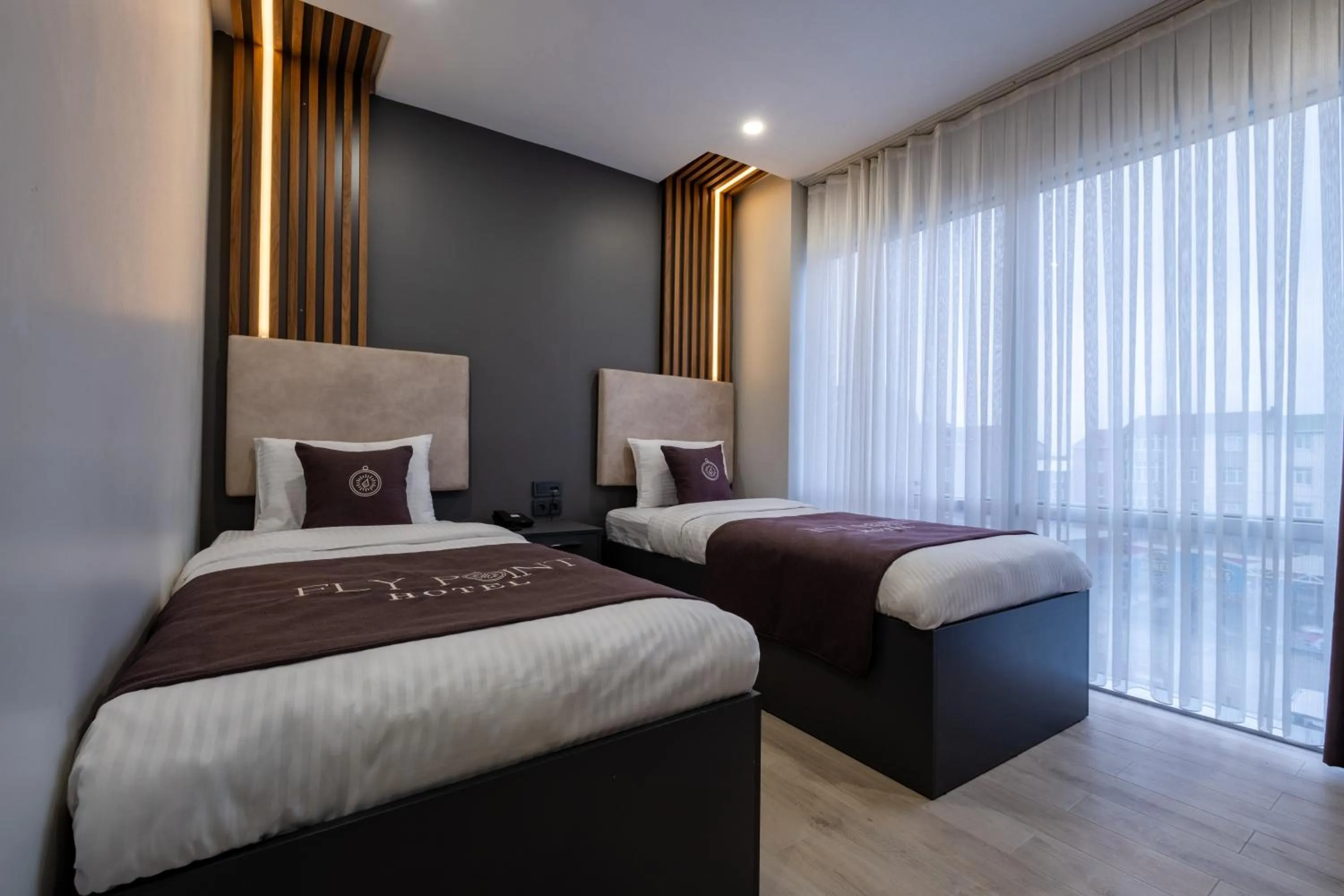 Bed in FLY POINT AIRPORT HOTEL