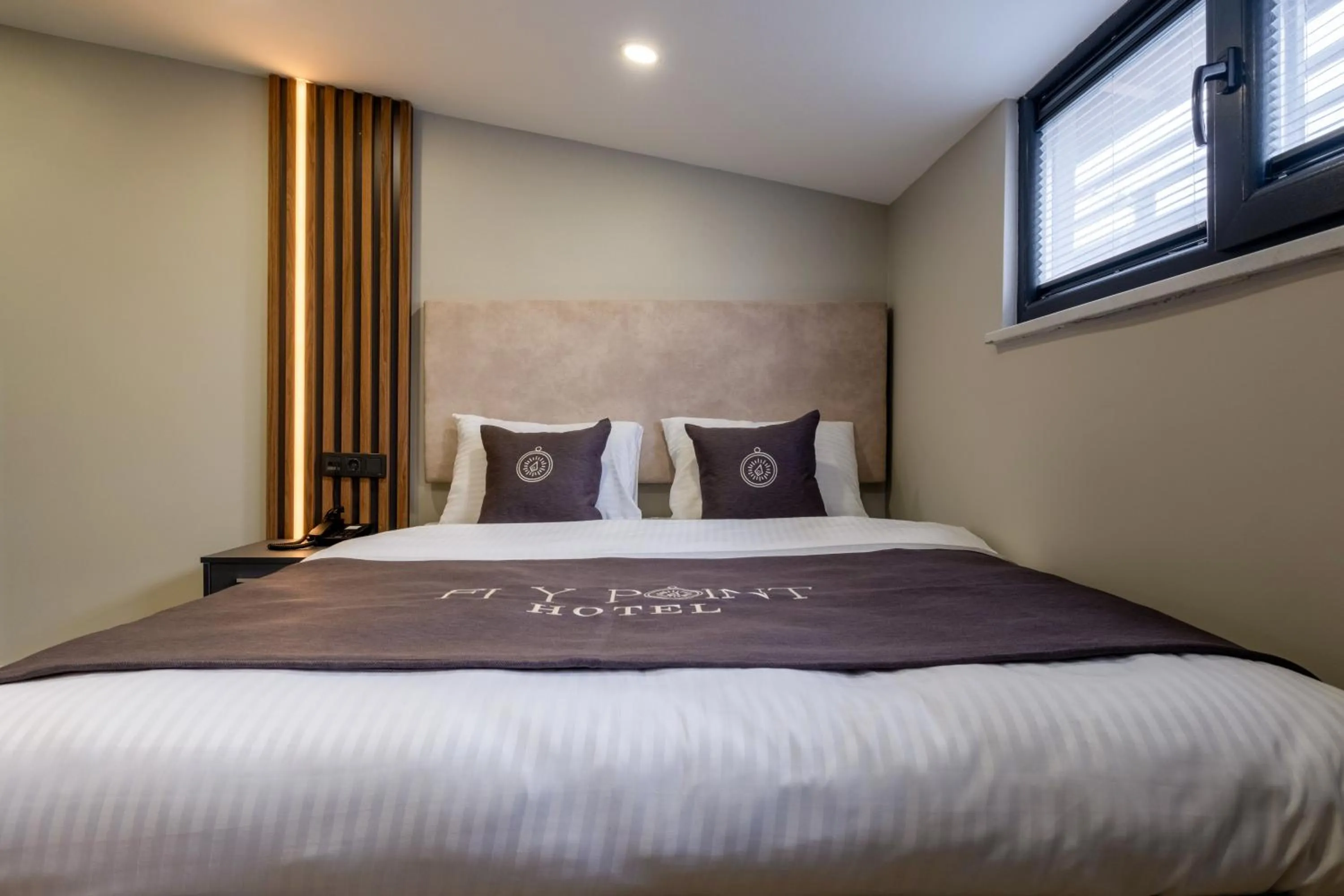 Bed in FLY POINT AIRPORT HOTEL