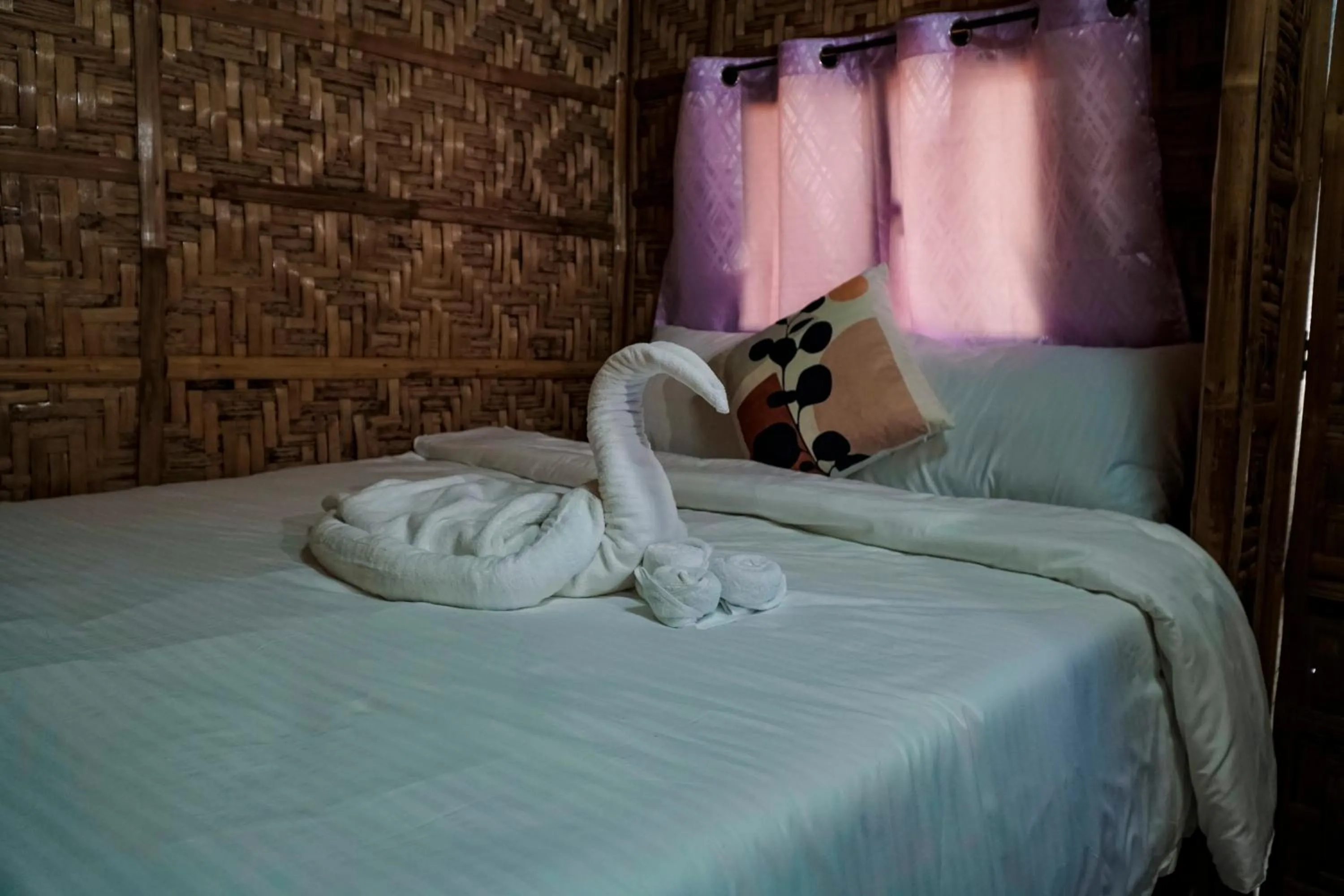 Bed in The Blessed Purple Bamboo Beach Resort