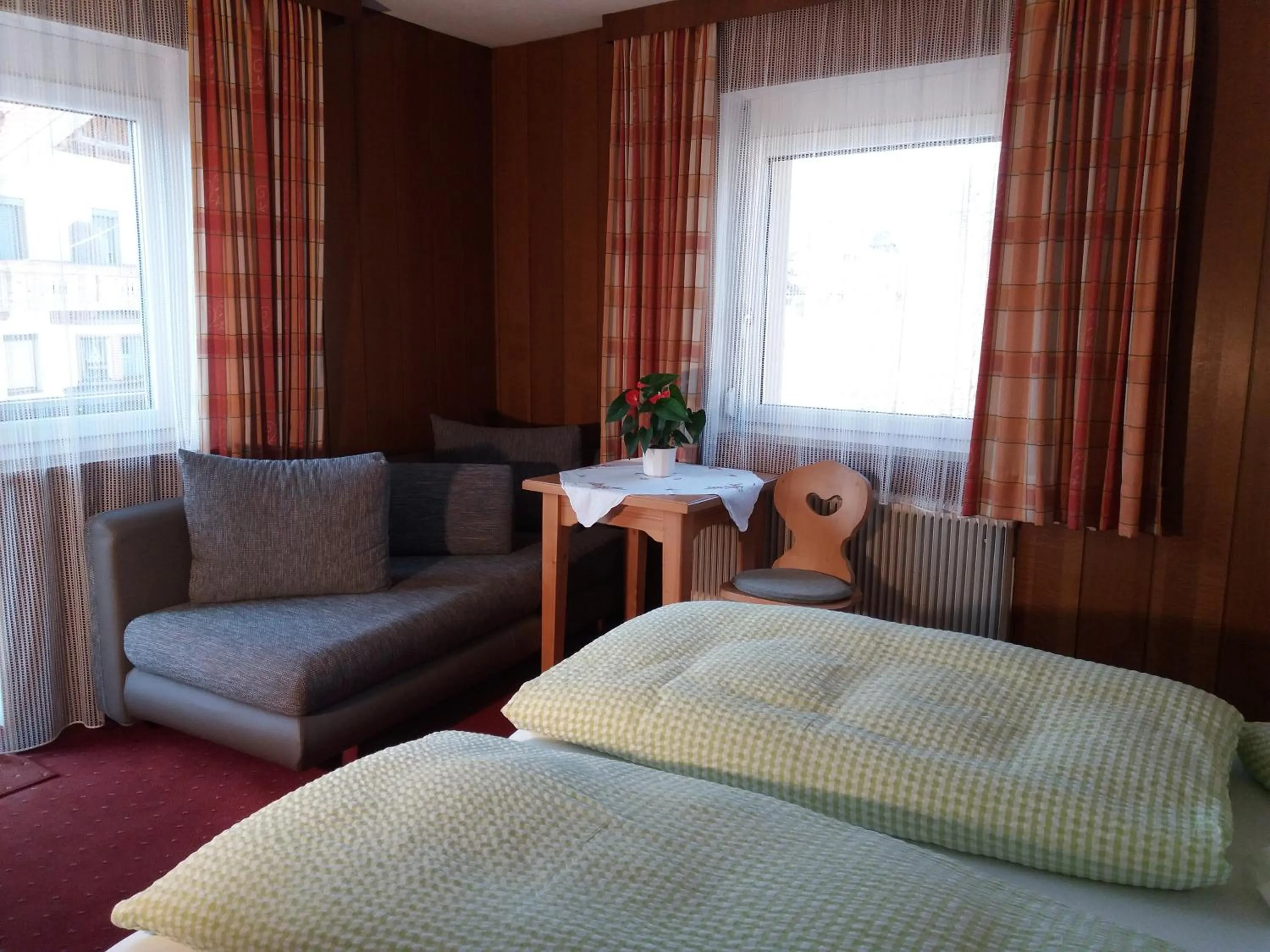 Seating area, Bed in Pension Sonnenhof