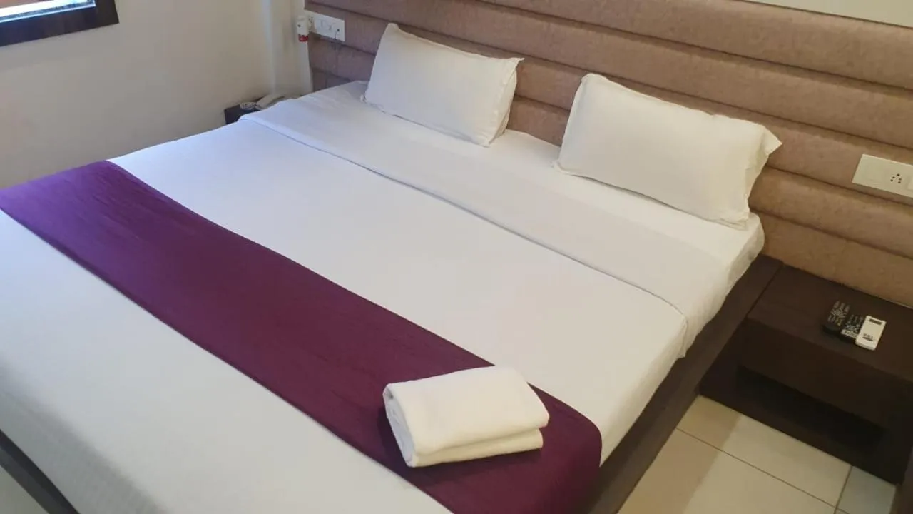 Bed in Hotel Siddhali Inn