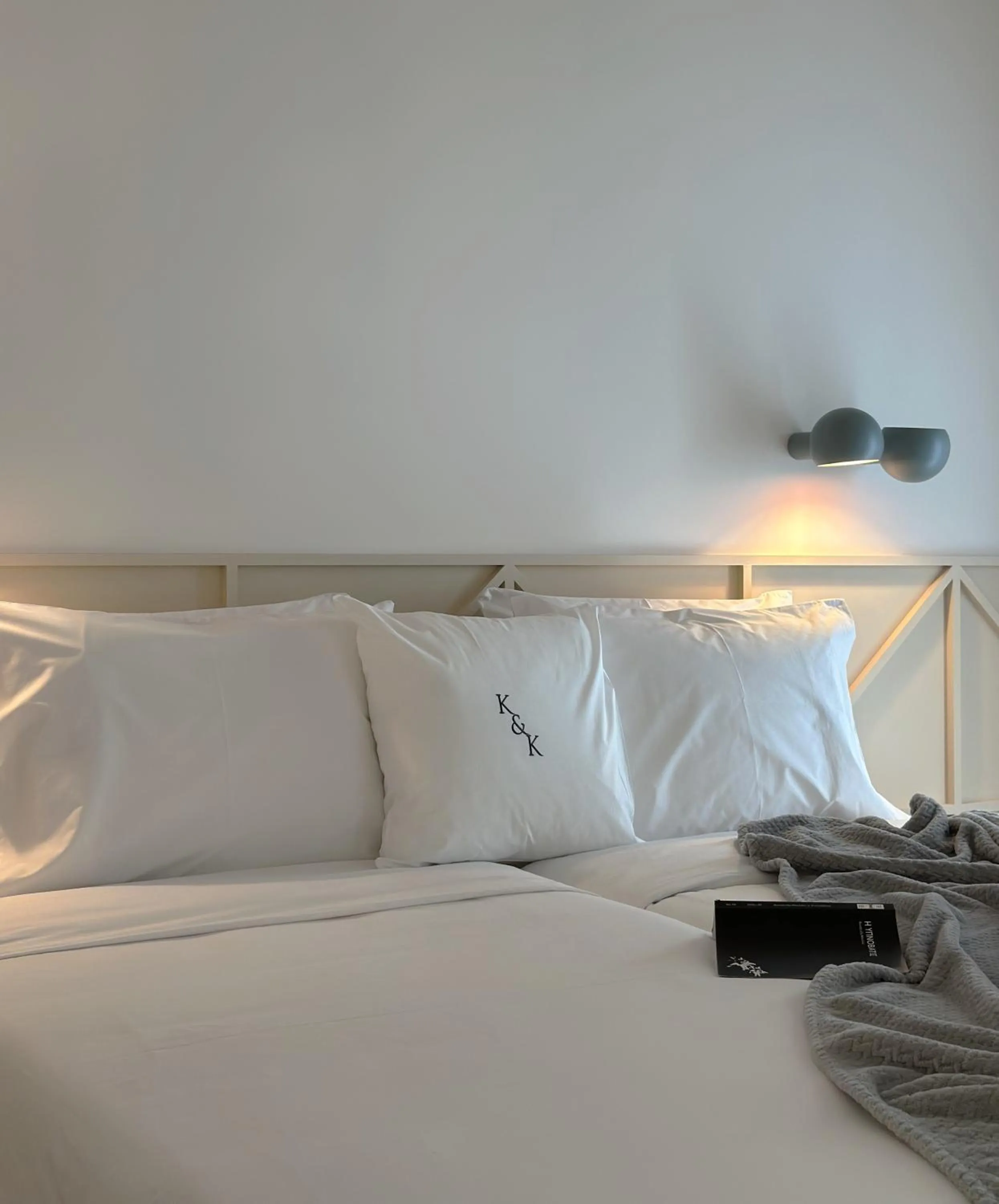 Bed in AIONION RESIDENCES by K&K