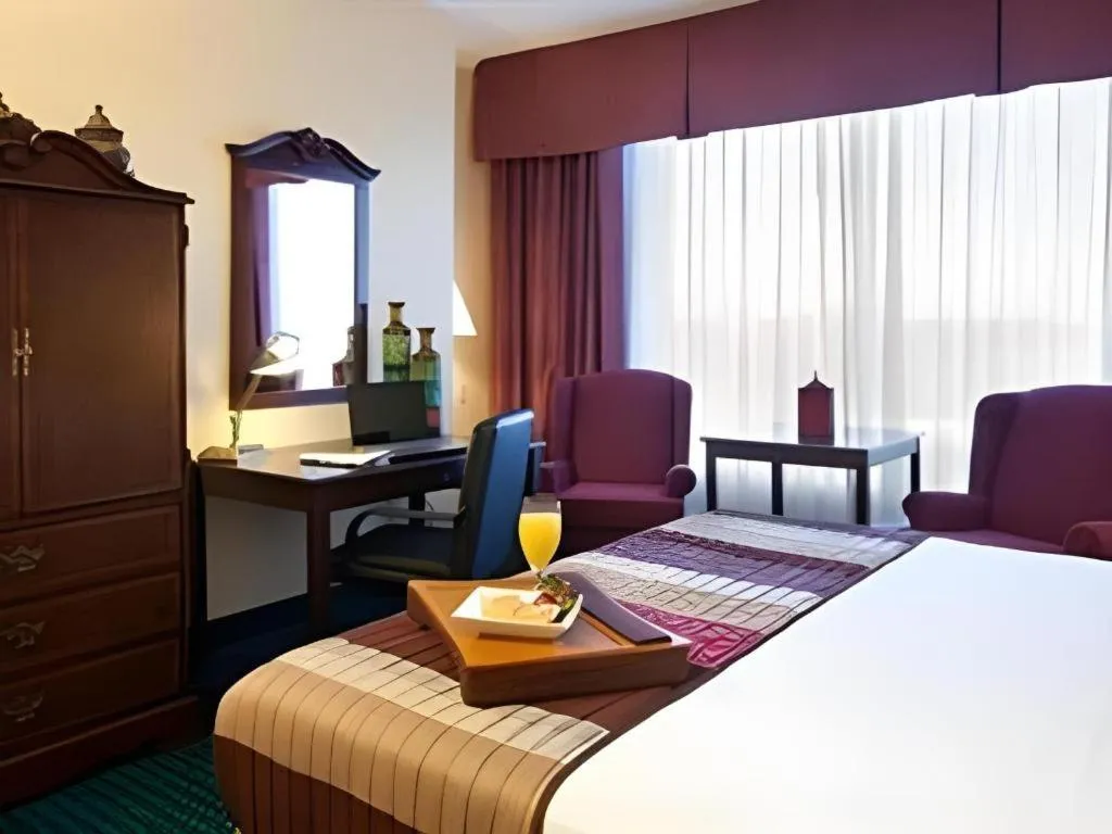 Bed in Magnuson Grand Conference Hotel