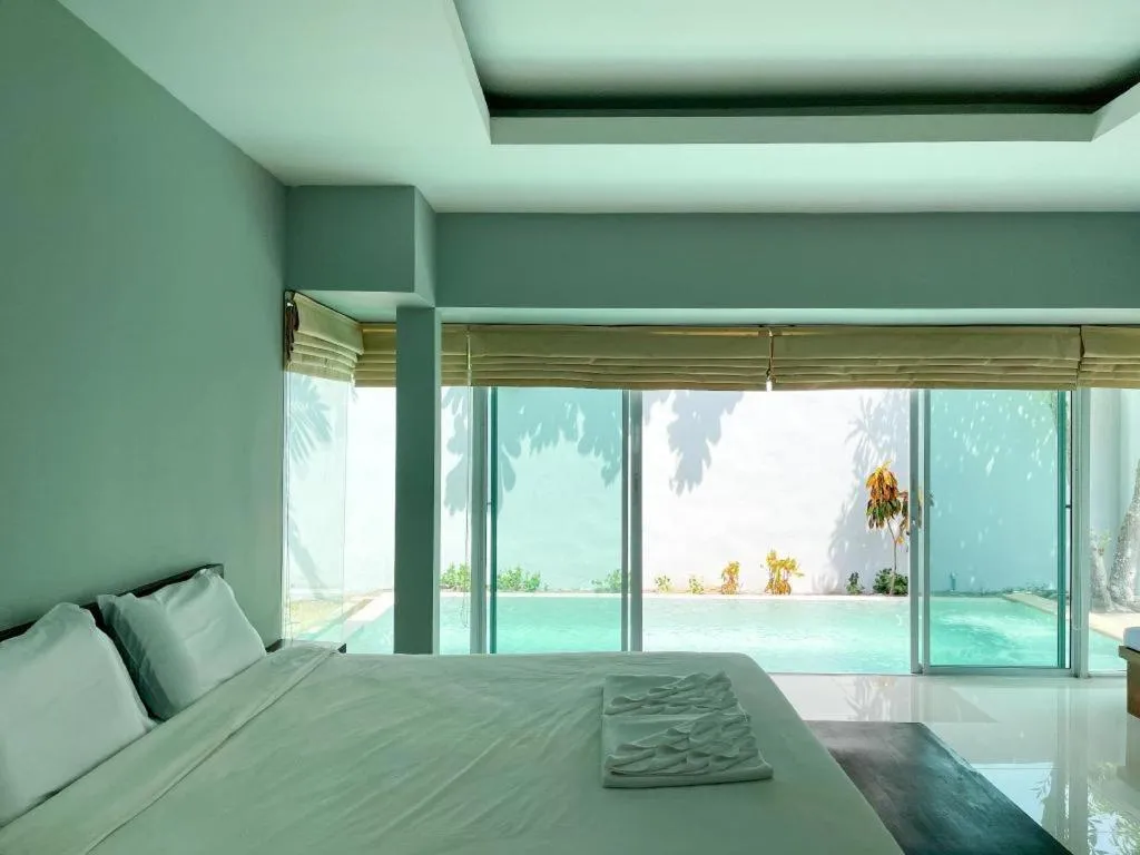 Bed in The Living Pool Villas