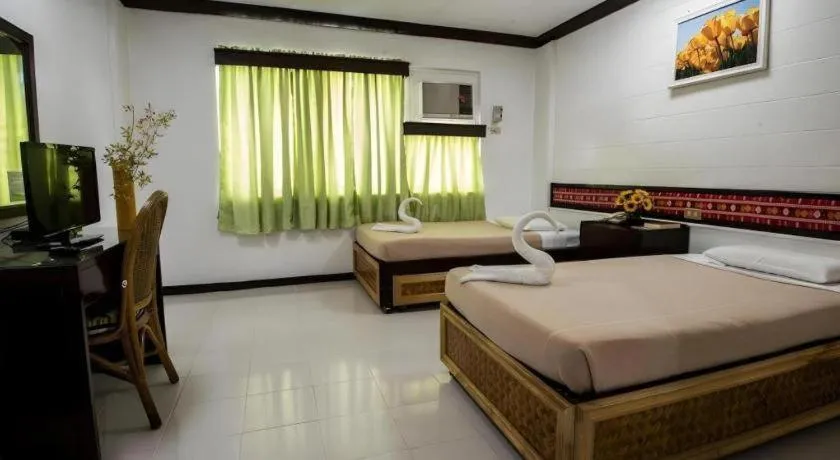 Bed in Family Country Hotel and Convention Centre