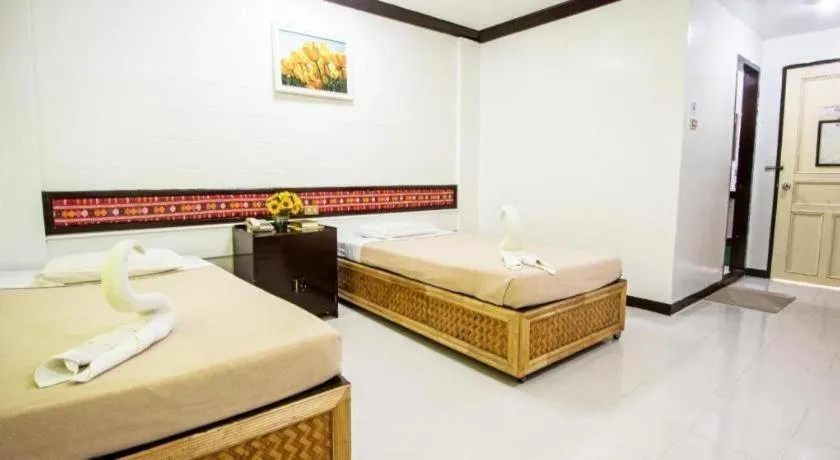 Bed in Family Country Hotel and Convention Centre