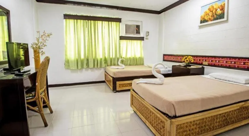 Bed in Family Country Hotel and Convention Centre