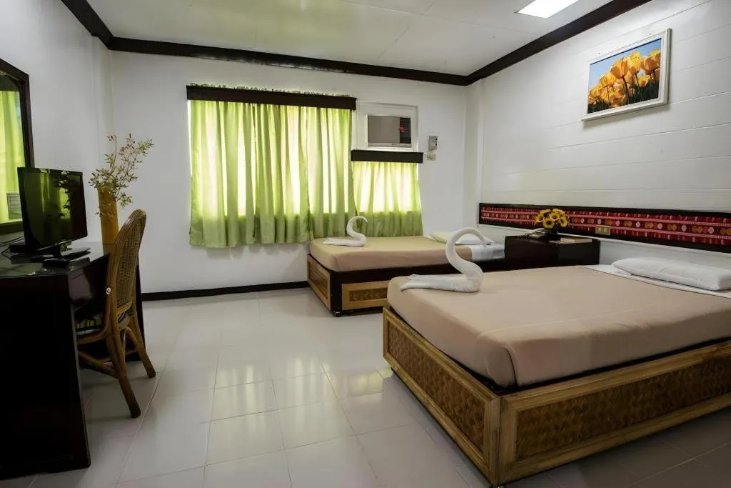 Bed in Family Country Hotel and Convention Centre