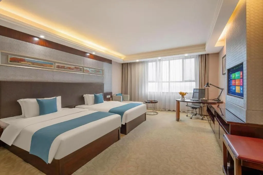 Bed in Aksu Pudong Holiday Hotel