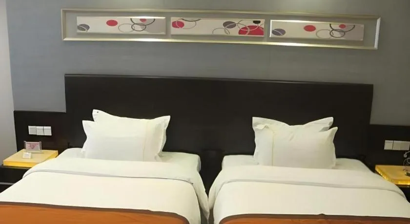 Bed in Aksu Pudong Holiday Hotel