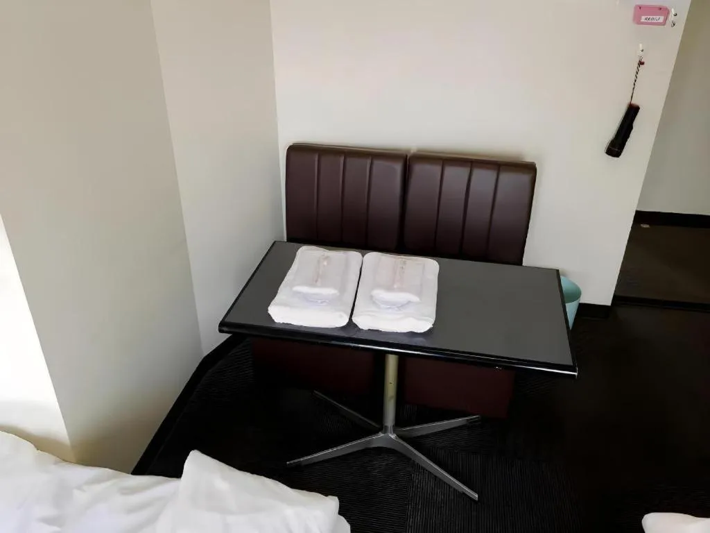 Bed in New Shochikubai Hotel