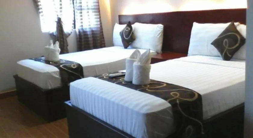 Bed in Rovic's Tourist Hotel