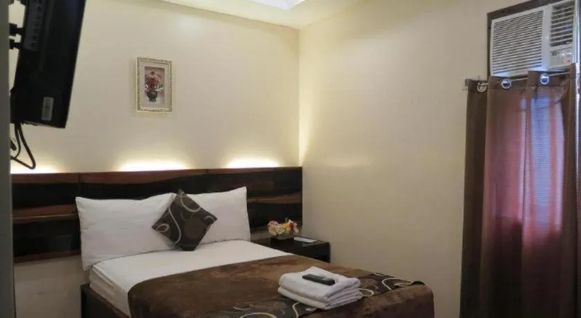 Bed in Rovic's Tourist Hotel