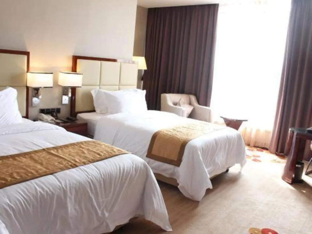 Bed in Golden Phoenix International Hotel