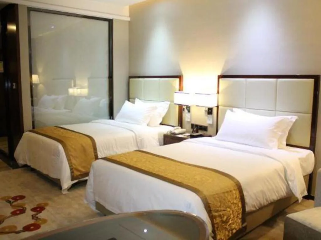 Bed in Golden Phoenix International Hotel