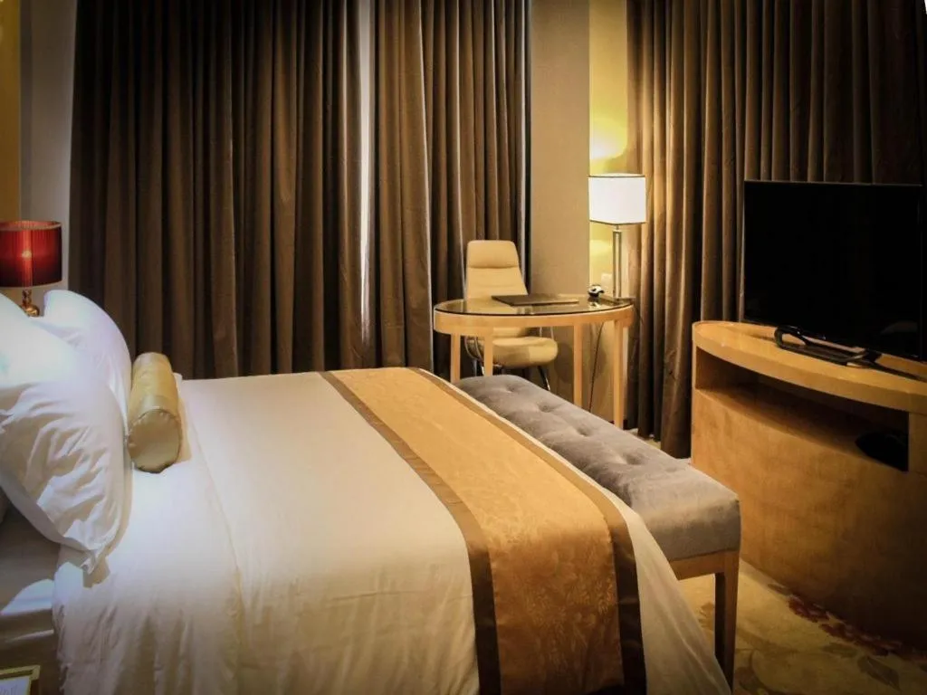 Bed in Golden Phoenix International Hotel