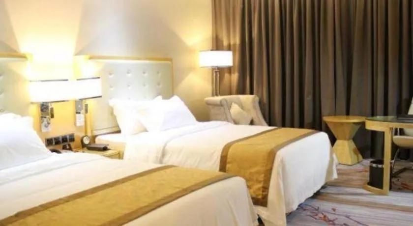 Bed in Golden Phoenix International Hotel