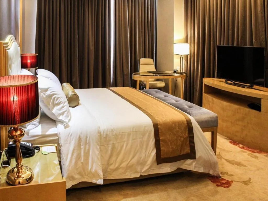Bed in Golden Phoenix International Hotel