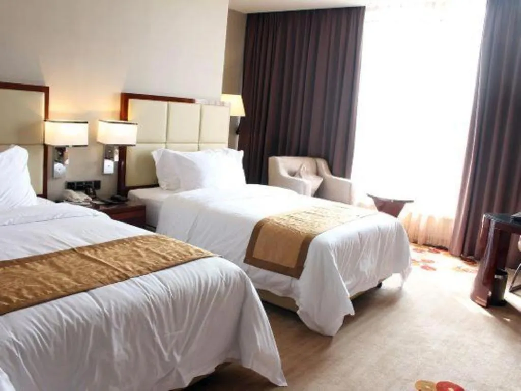 Bed in Golden Phoenix International Hotel