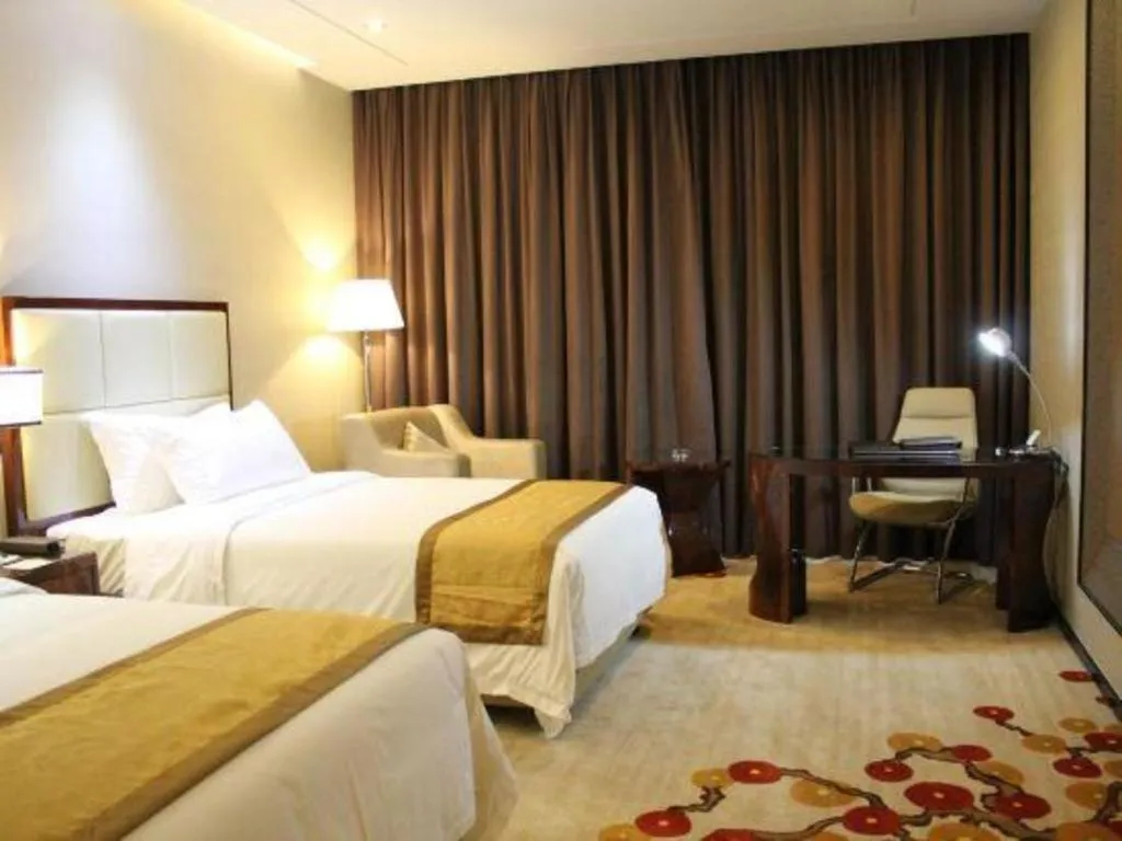 Bed in Golden Phoenix International Hotel