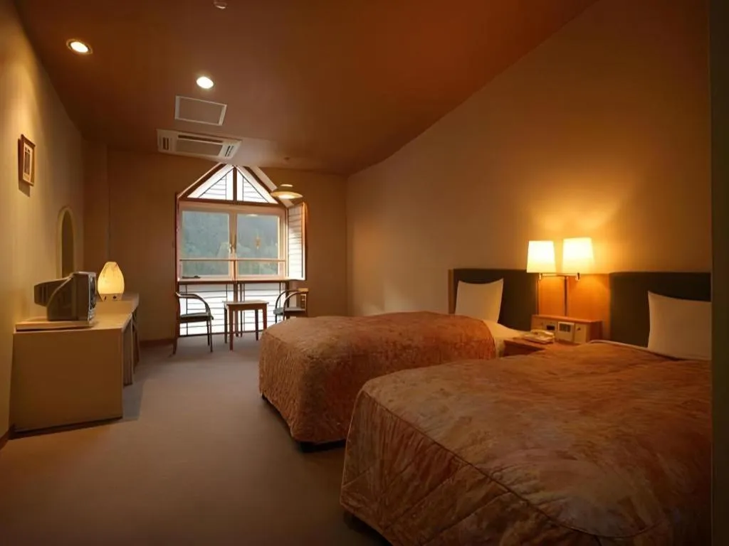 Bed in Hotel Hikyounoyu