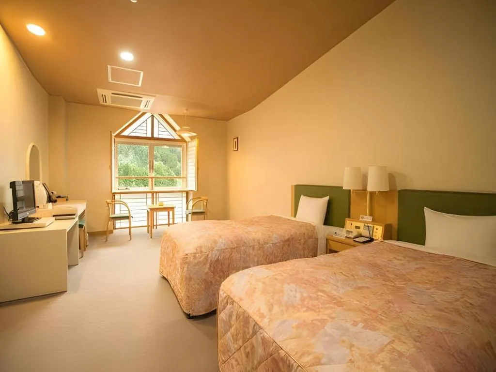 Bed in Hotel Hikyounoyu