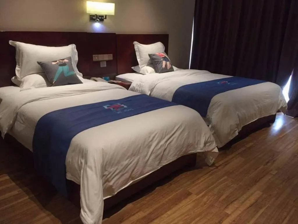 Bed in PAI Hotel Guangzhou North Gate of Chimelong Zoo