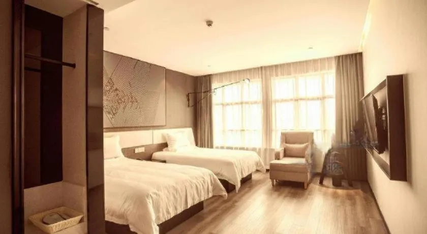 Bed in IU Hotel Qingdao Golden Beach Xuejiadao Metro Station